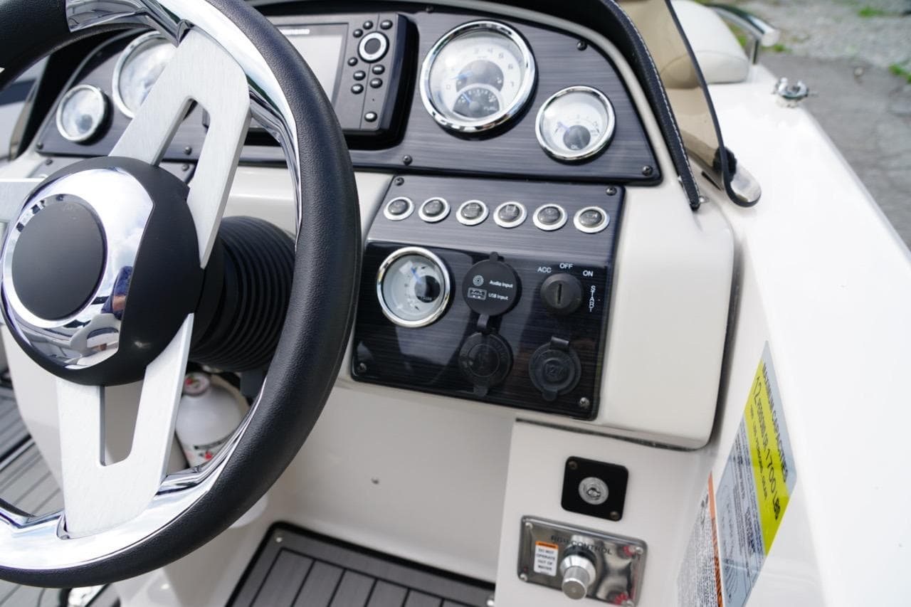 2019 Starcraft Star Step 221 E I/O boat dashboard with steering wheel and control panel.