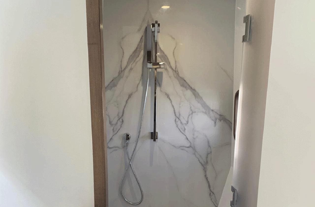 Modern shower in 2025 Aventura 38 Sport Coupe with marble-style wall design.
