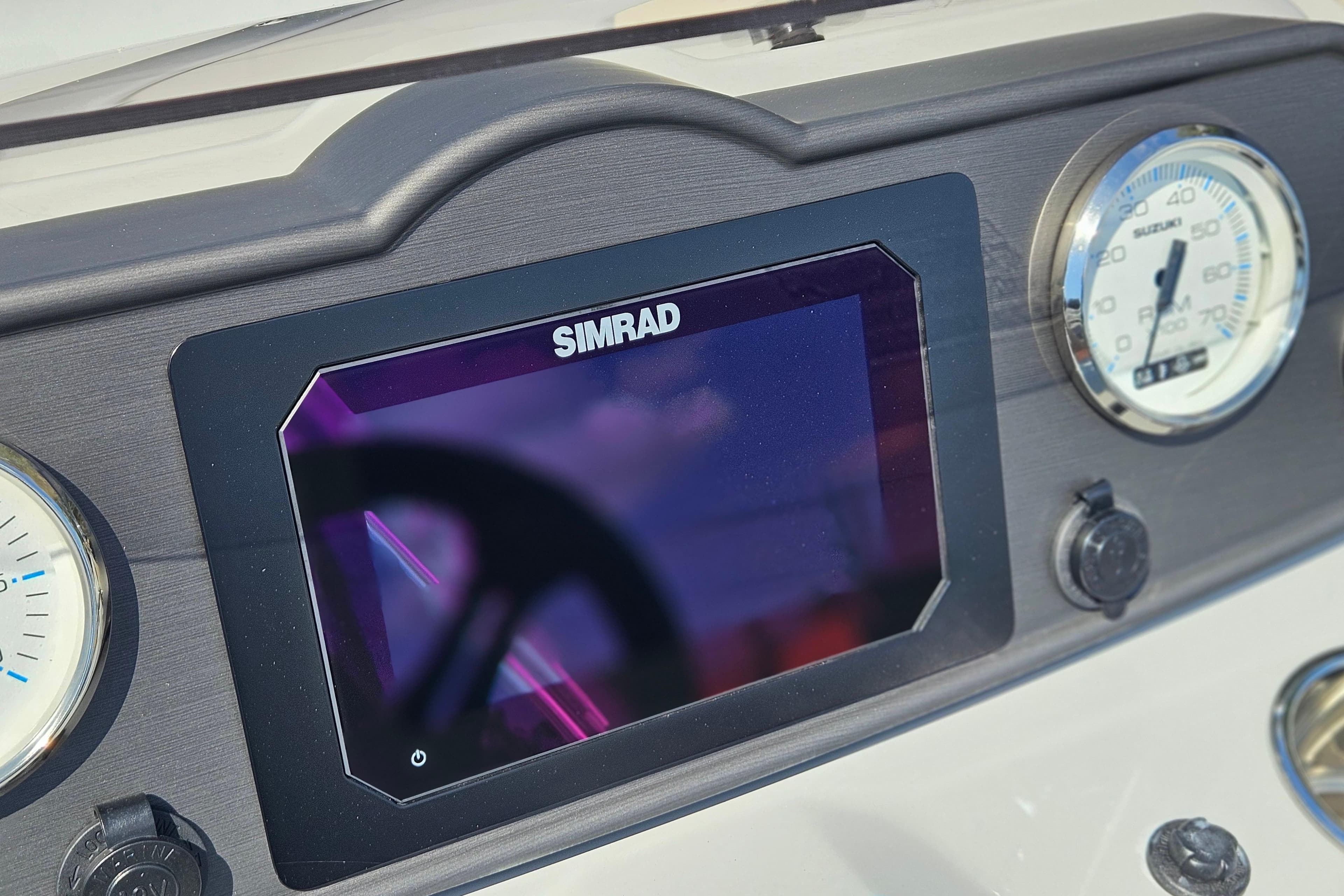 Dashboard of 2026 Bentley Pontoons 203 Fish-N-Cruise with Simrad display and gauges.