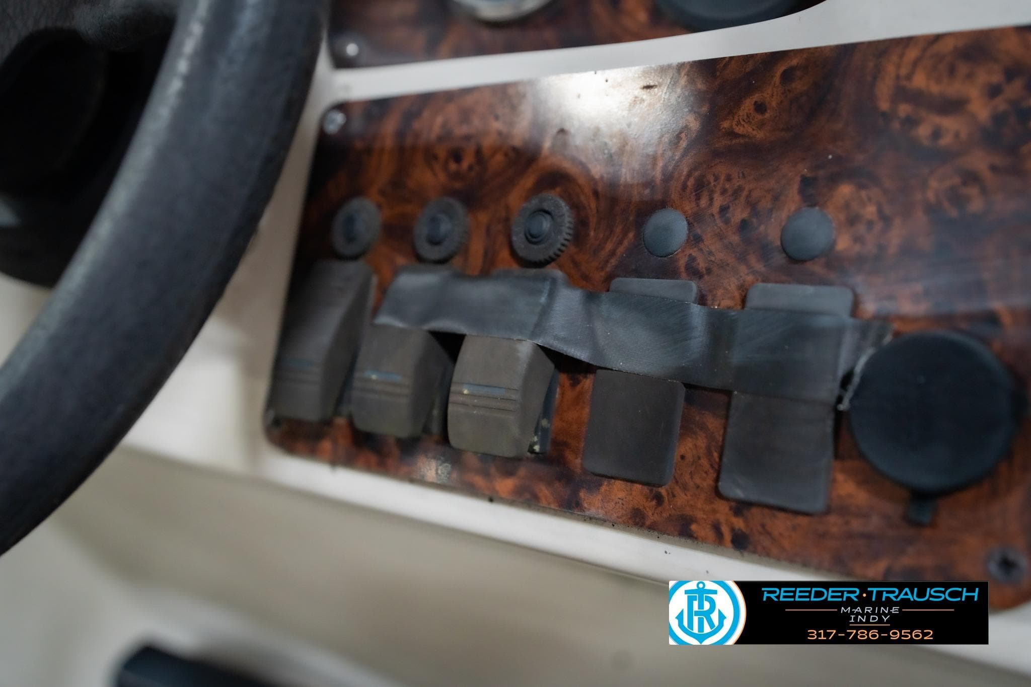 1998 Odyssey 25 dashboard with wood paneling and control switches.