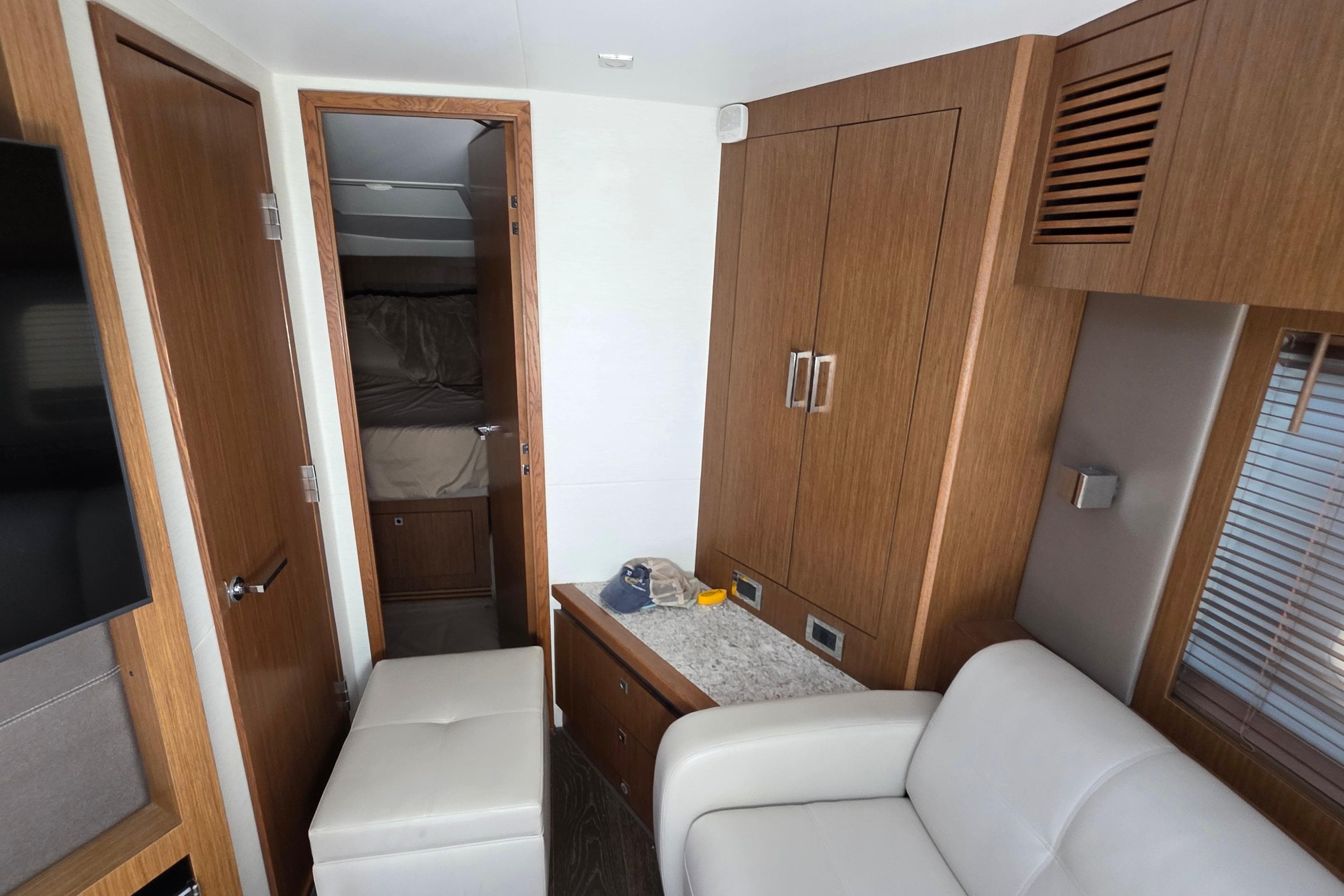 Interior of 2018 Sea Ray Sundancer 510 yacht with modern wood cabinetry and seating.