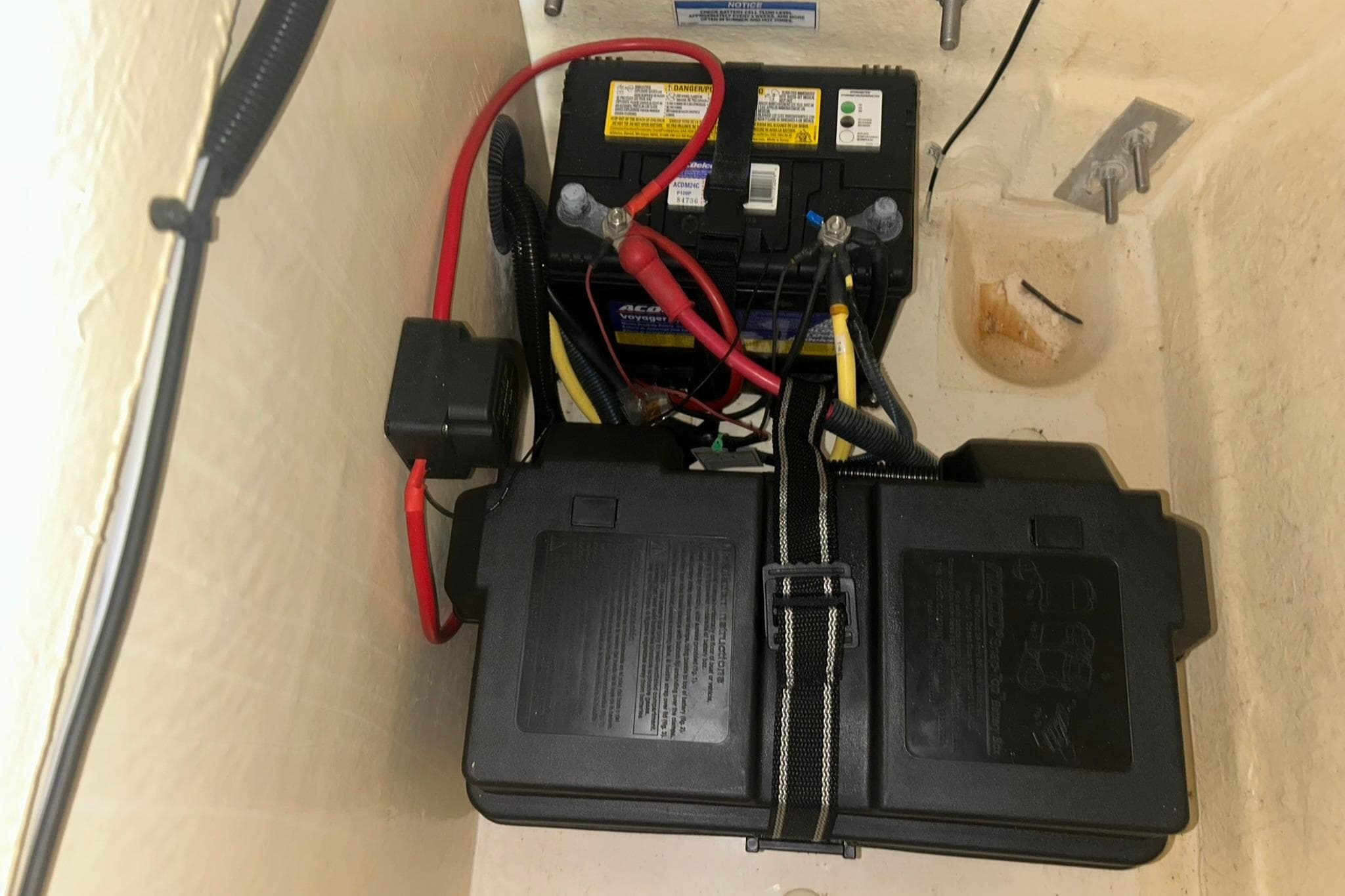Battery compartment of 2017 Bayliner VR6 Bowrider I/O with wiring and secure casing.