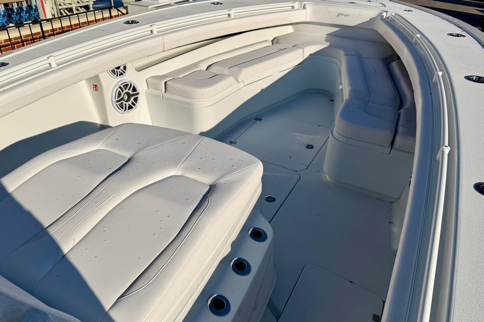 2026 Yellowfin 36 Offshore boat interior with cushioned seating and speakers.
