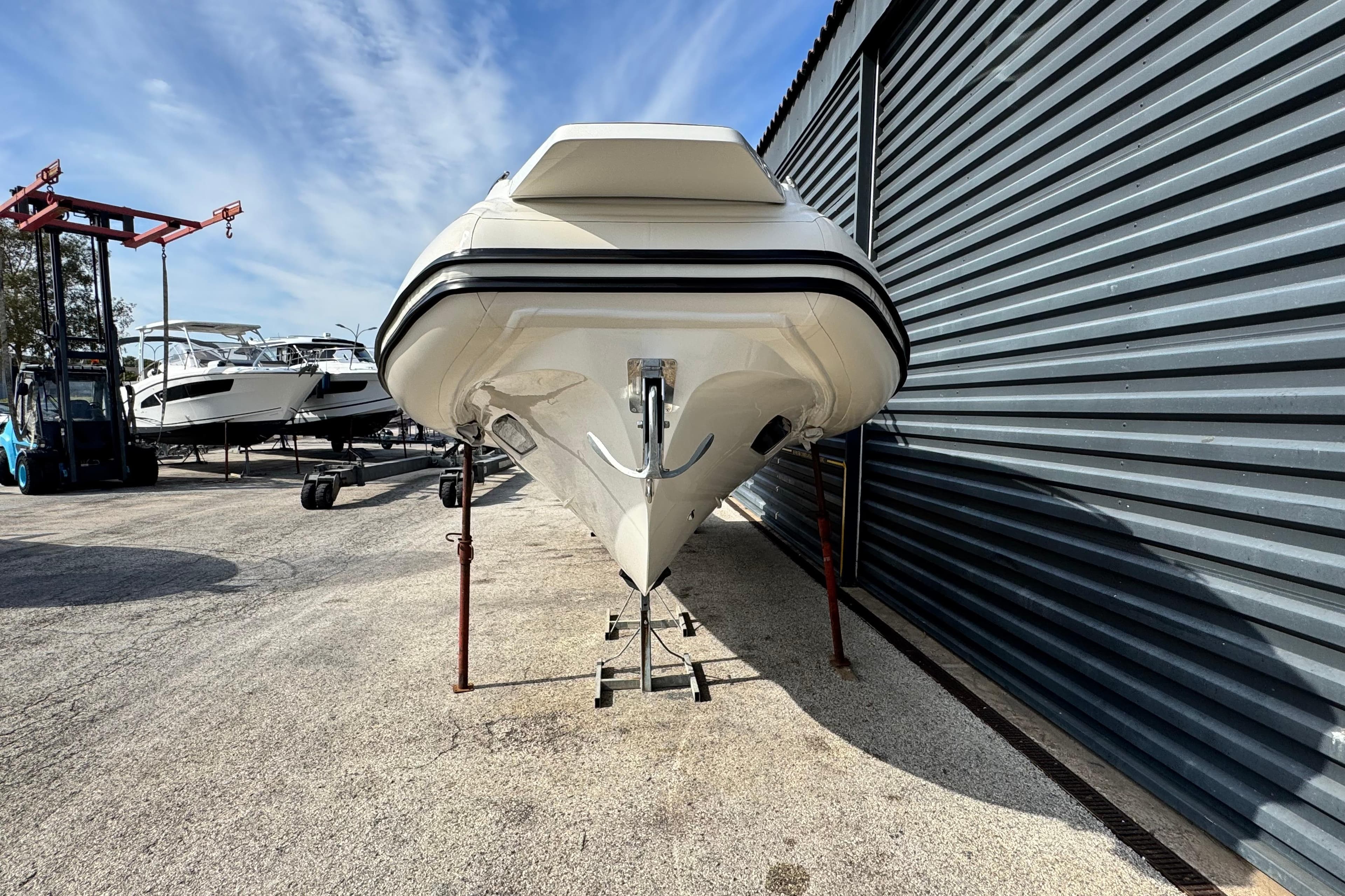 2025 Nuova Jolly Prince 30 Sport Cabin boat in storage, side view.