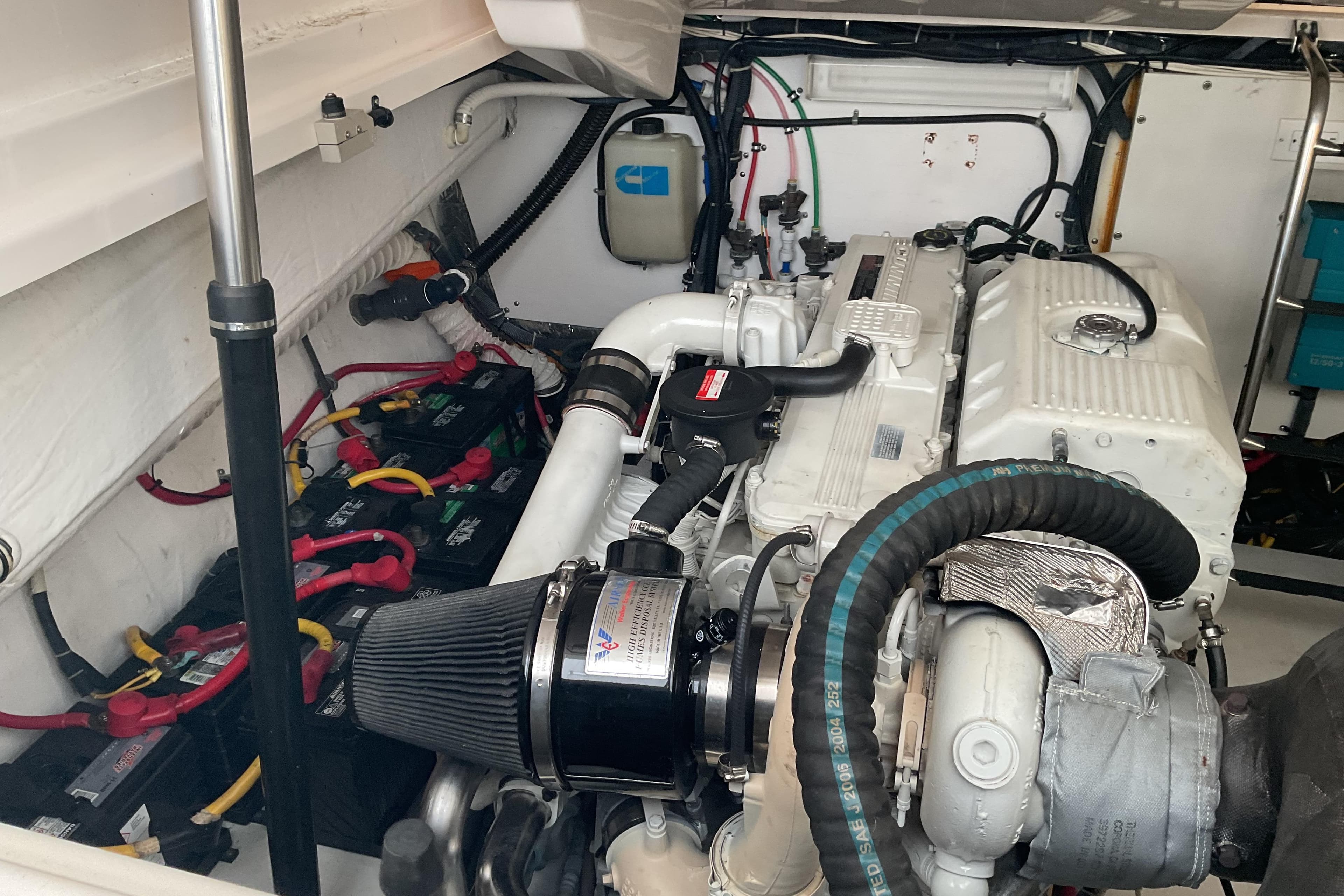 Engine room of a 2006 Tiara Yachts 3800 Open, showcasing batteries and engine components.
