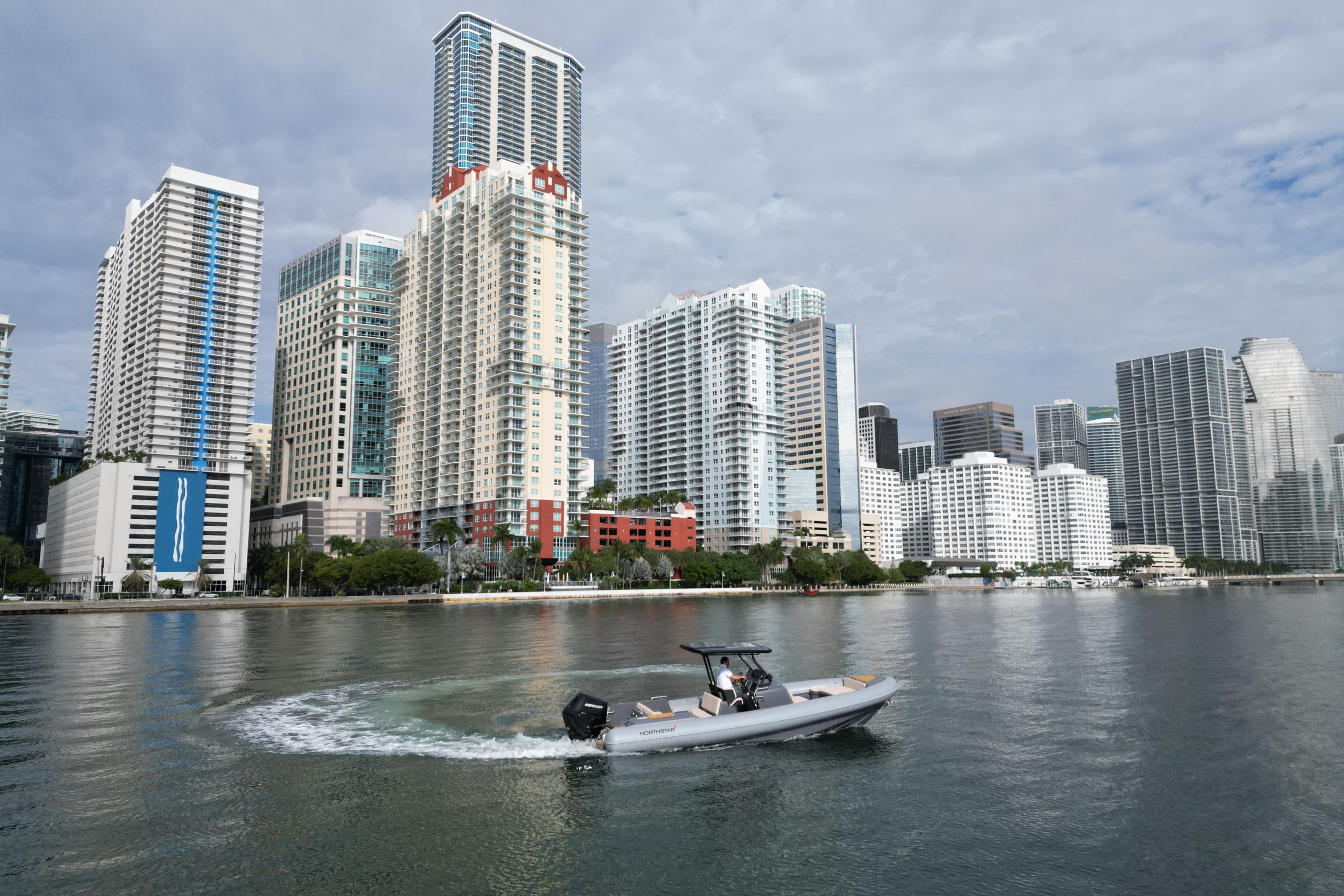 Boat cruising near city skyline, Northstar Orion 8, 2026 model.