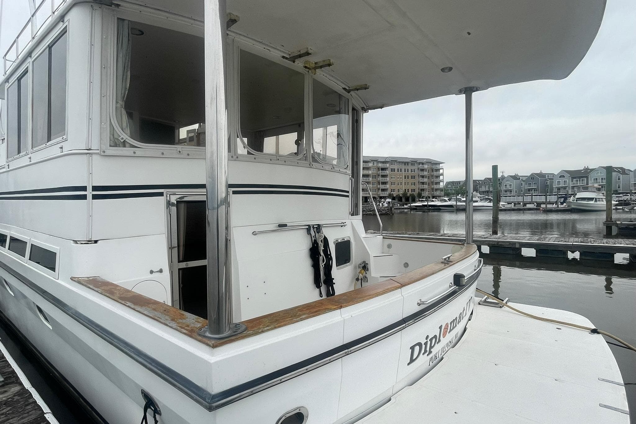 2001 Novatec Islander yacht docked at marina, showcasing spacious deck and sleek design.