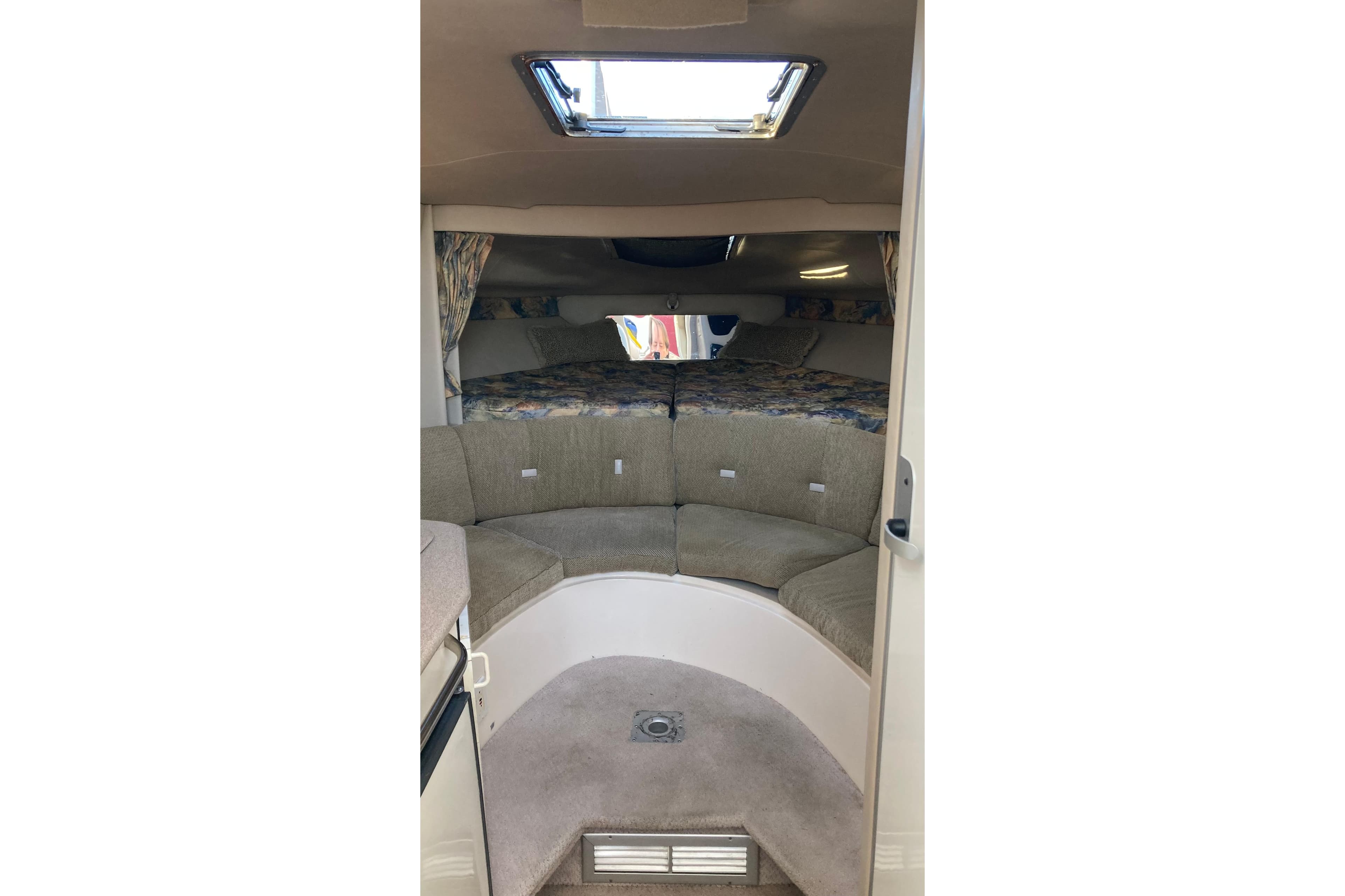 1999 Chaparral Signature 29 cabin interior with seating and bedding area.