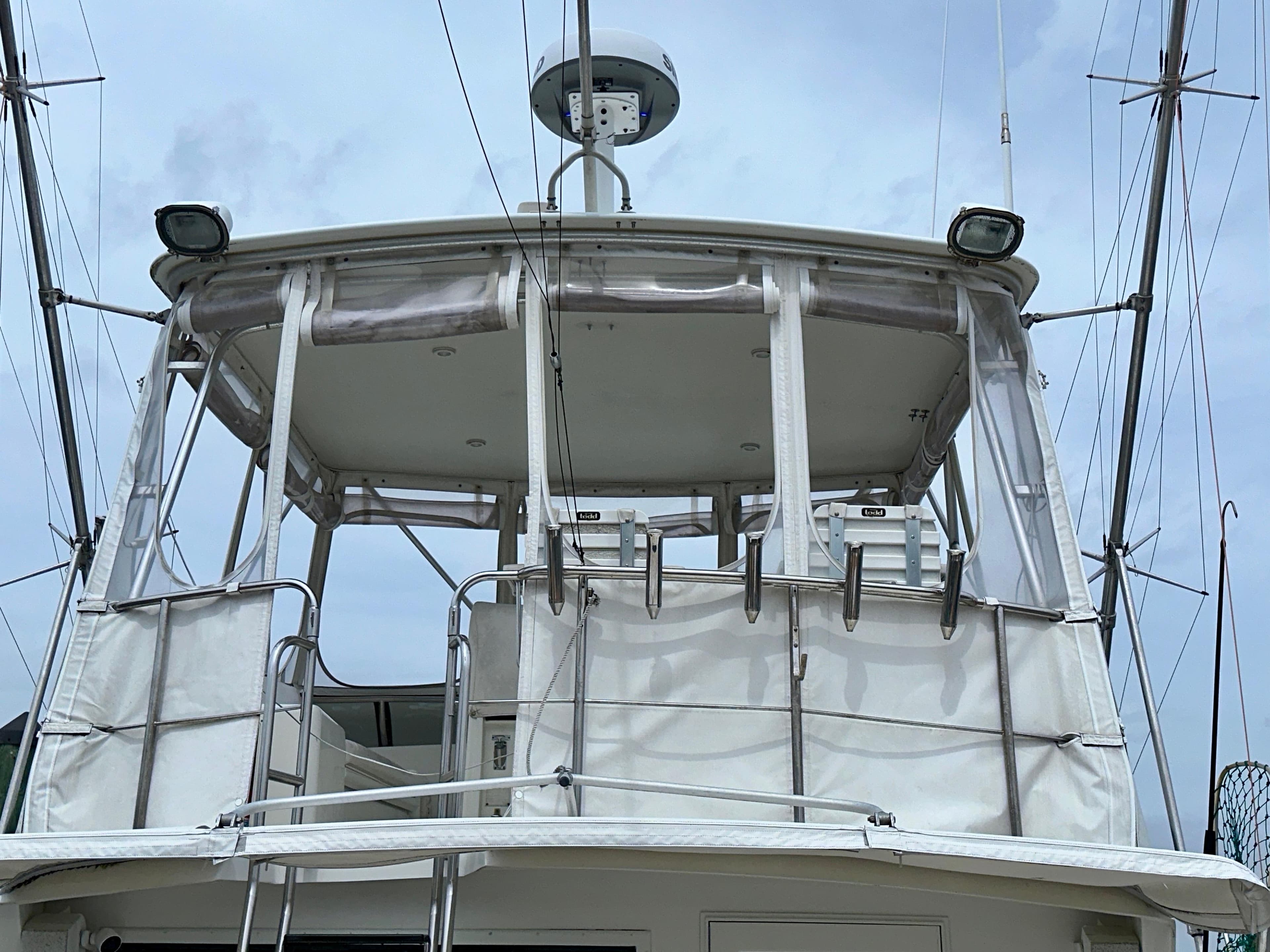 1994 Hatteras 46 Convertible yacht with enclosed flybridge, featuring radar and antennas.