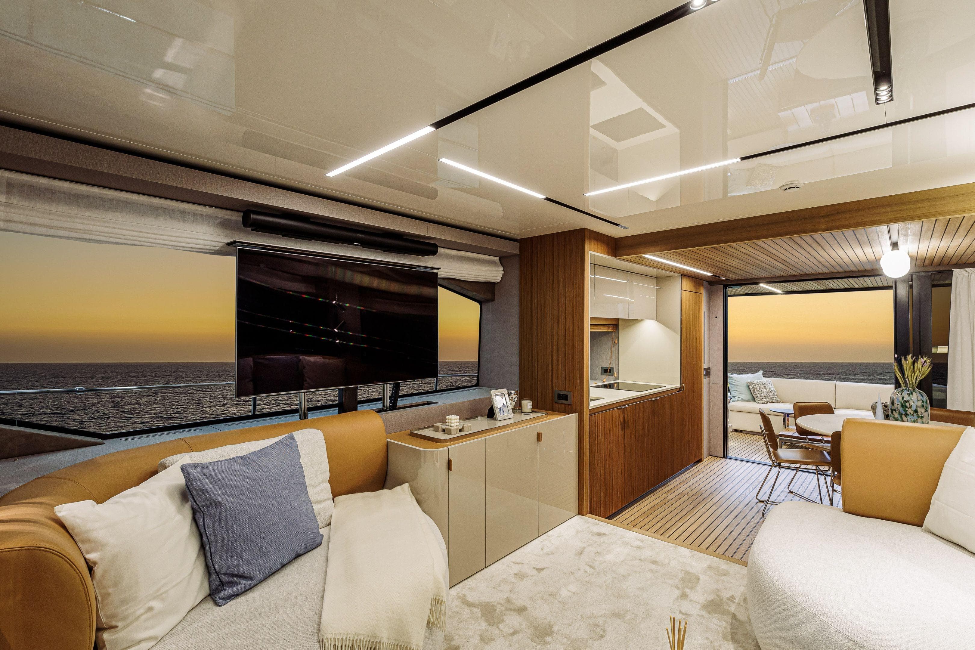 Luxurious interior of 2026 Cranchi Sessantadue 62 yacht with ocean view at sunset.