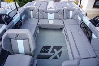 2025 MasterCraft XT22 T boat interior with gray seating and logo on floor.