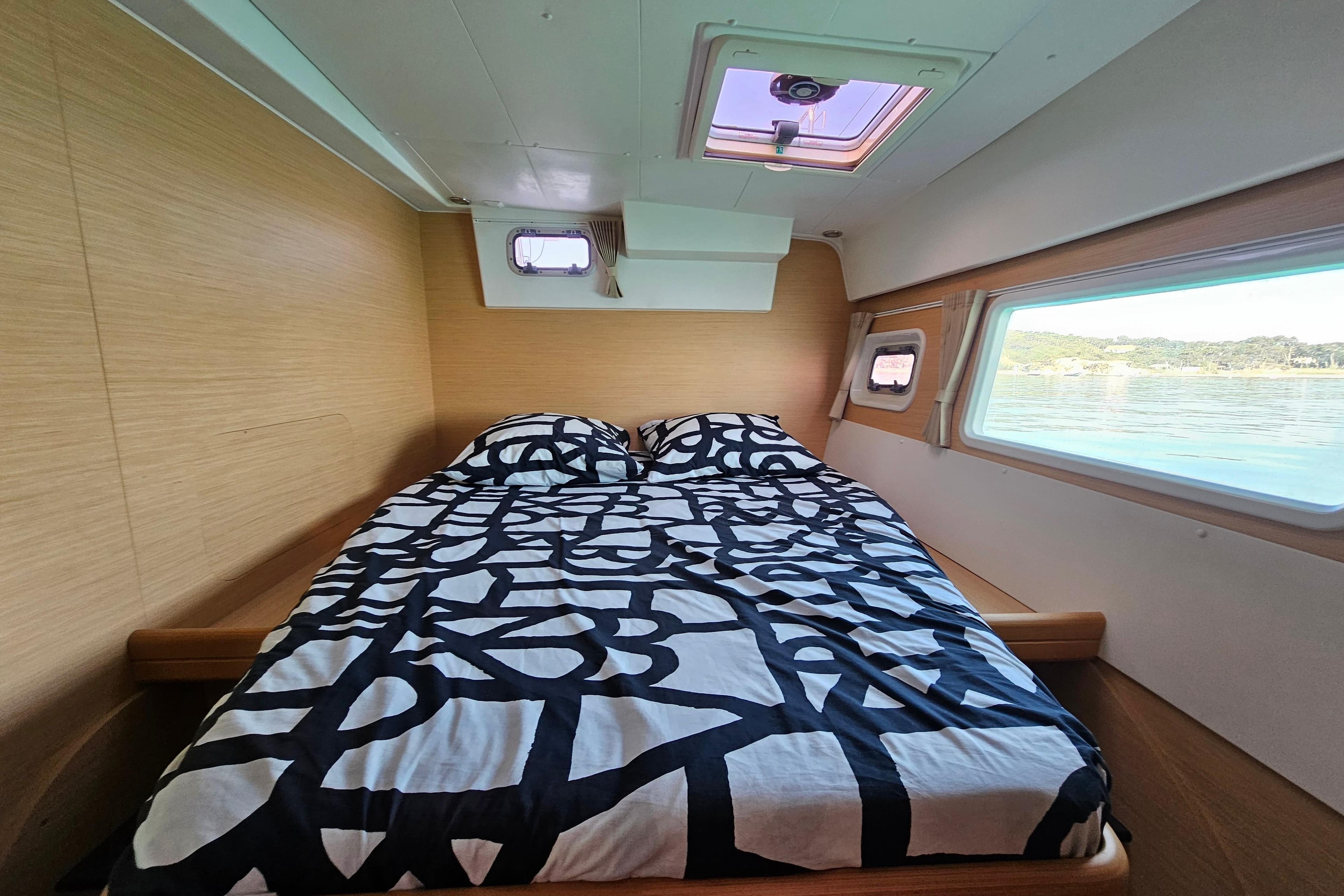 Interior cabin of 2008 Lagoon 420 yacht with bed and scenic window view.