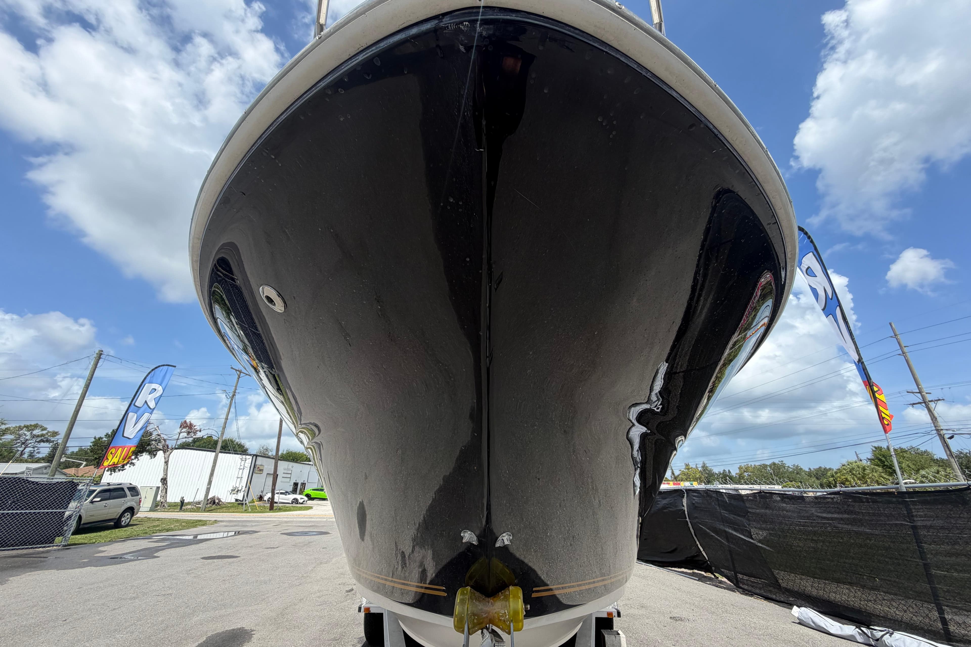 2006 Sea Ray 250 Amberjack boat on display under a clear blue sky.