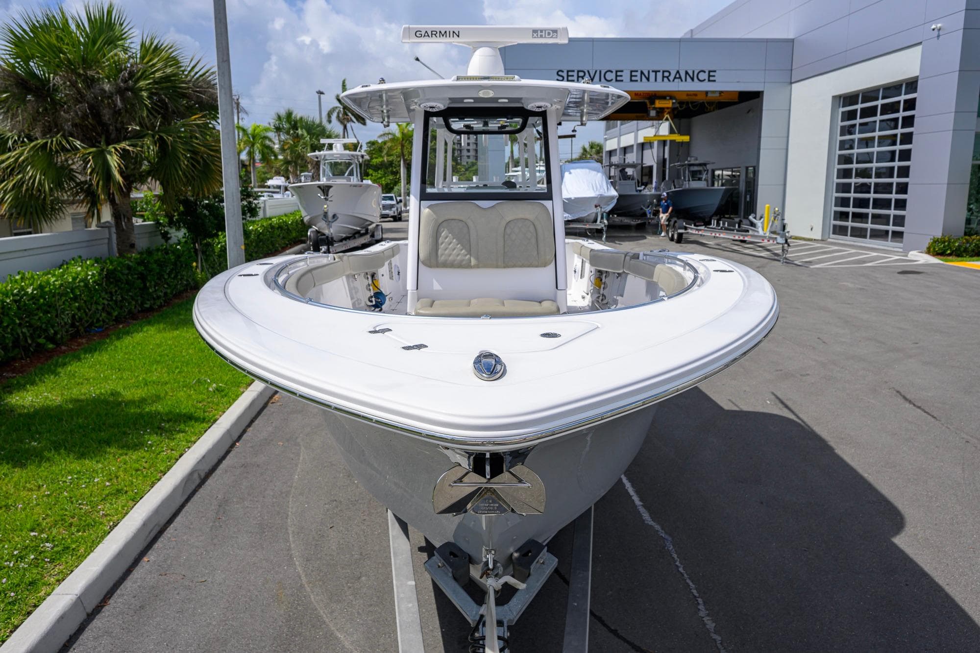 2023 Sportsman Open 302 Center Console boat at service entrance, sunny day.
