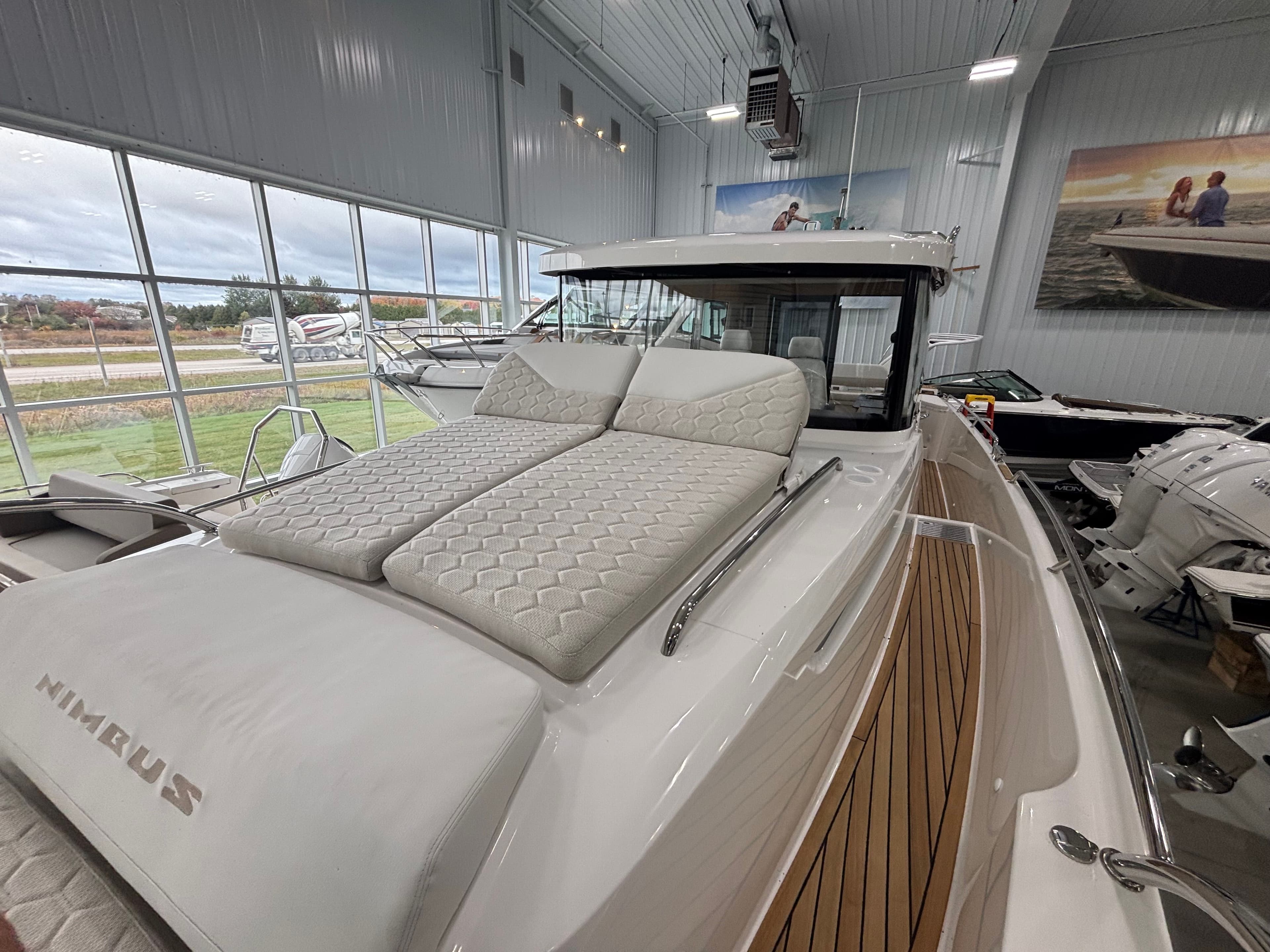 2026 Nimbus Commuter 11 MKII Legacy Edition boat with cushioned deck in showroom.