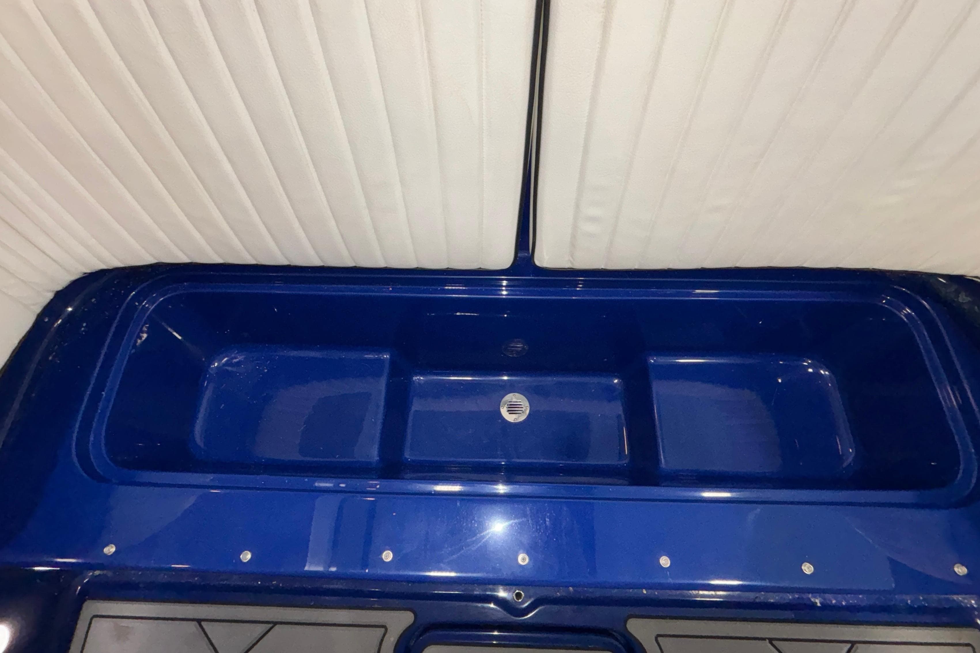 Interior view of a 2026 Donzi 22 Classic boat with blue detailing.