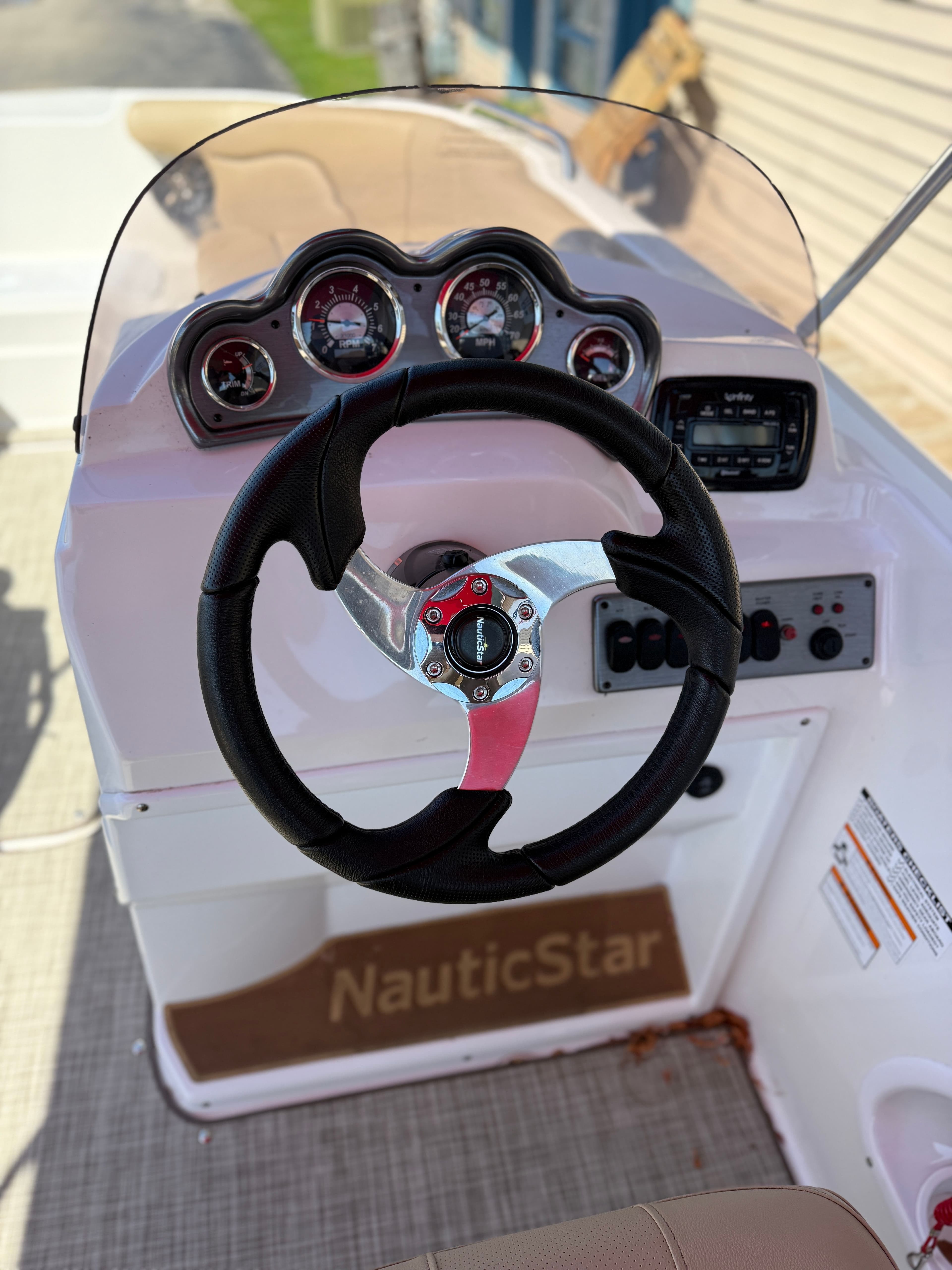 Steering console of a 2019 NauticStar 203SC boat with instruments.