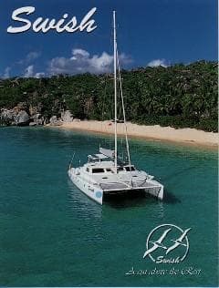 Catamaran "Swish" anchored near tropical beach, Voyage Mayotte 47, 1995 model.