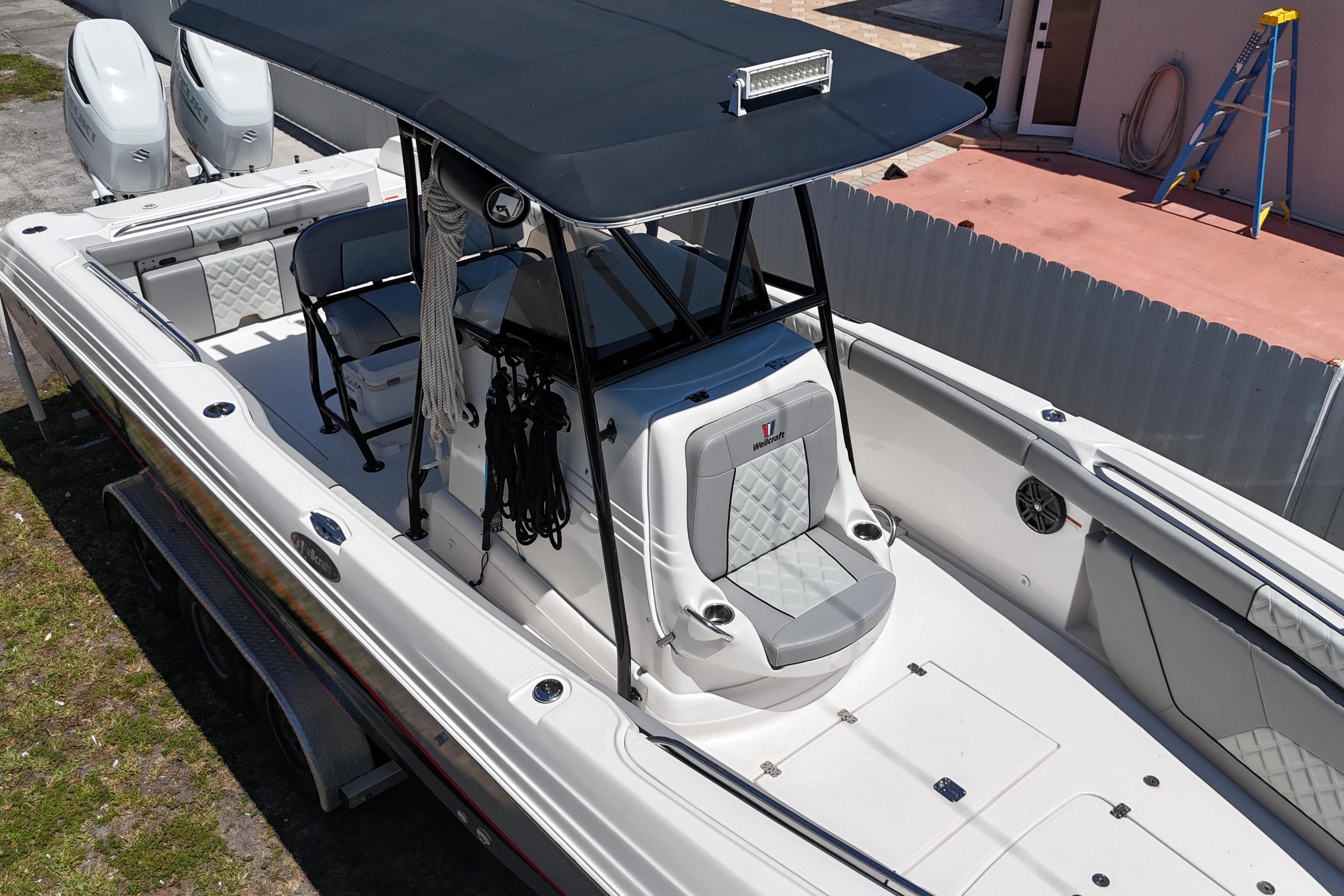 2006 Wellcraft 32 CCF boat with T-top and dual engines, parked on a trailer.