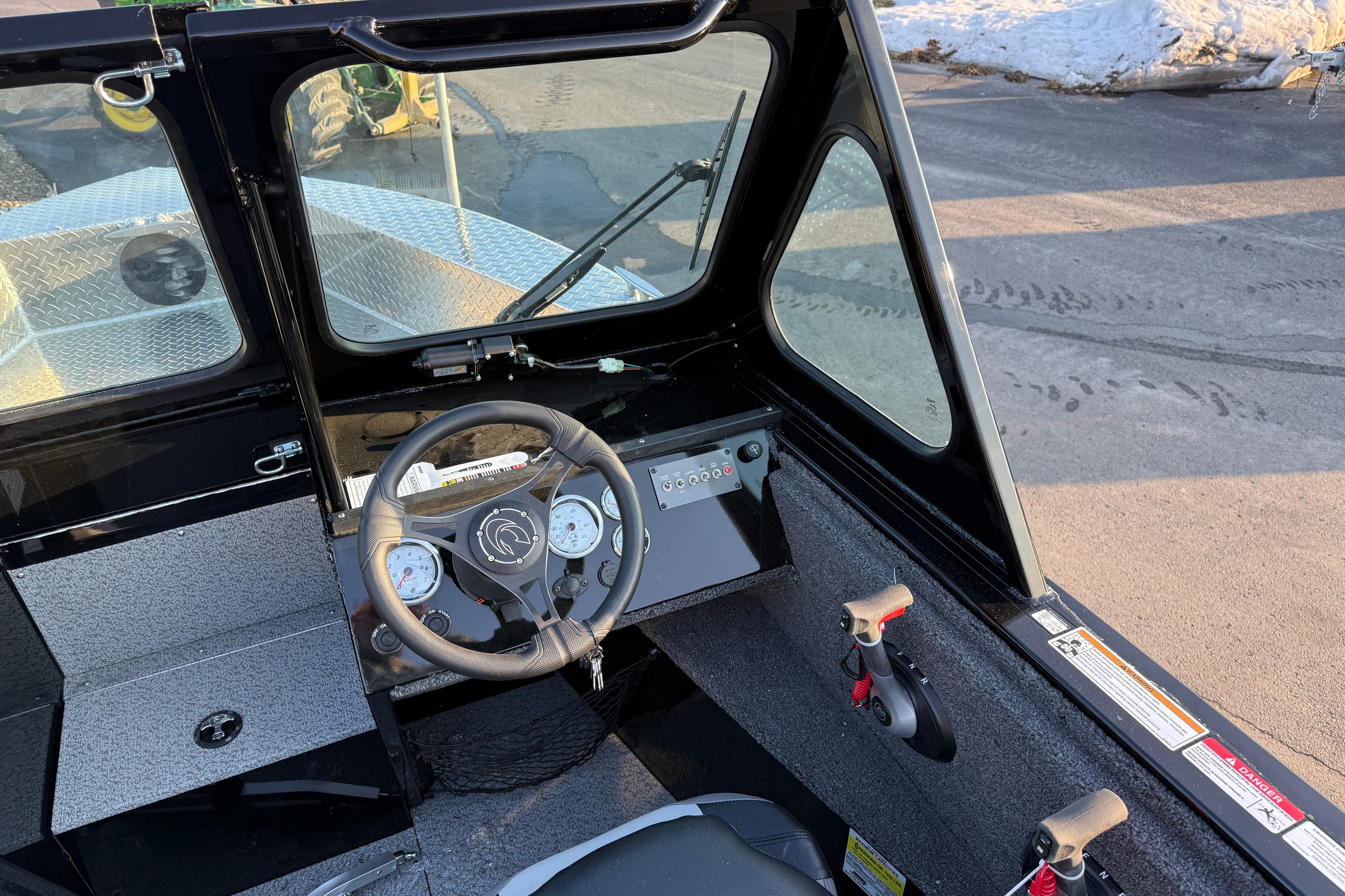2026 Crestliner 1850 Commander Elite boat cockpit with steering wheel and control panel.