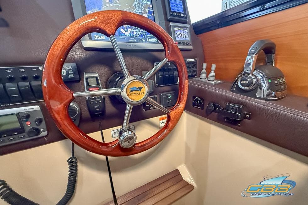 2013 Cutwater C-28 helm with wooden steering wheel and navigation controls.