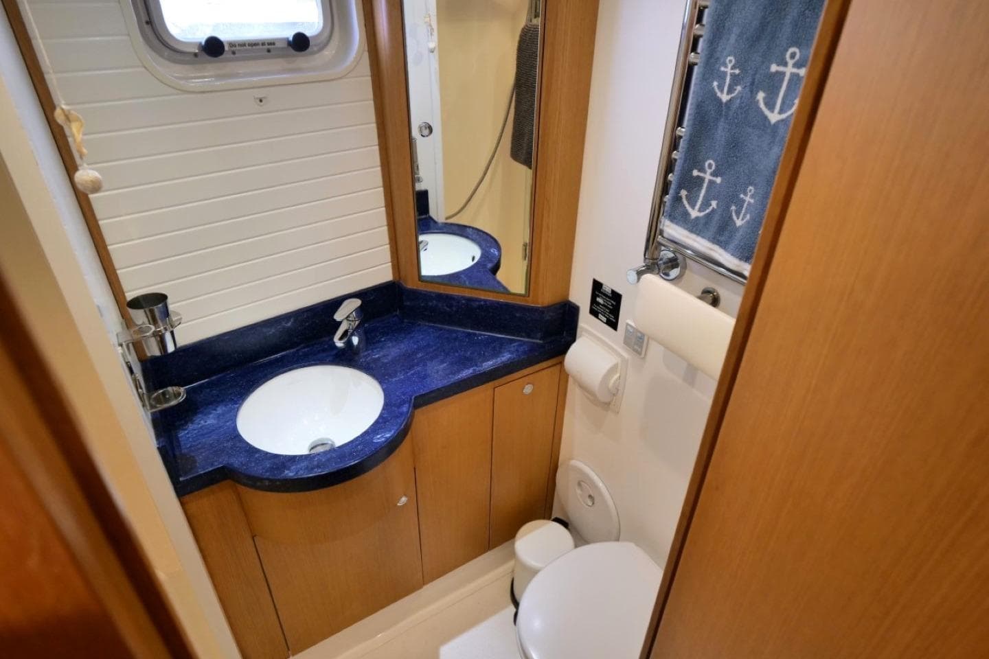 Bathroom interior of 2016 Bruce Roberts 16.5m Expedition Yacht, featuring blue countertop and nautical decor.