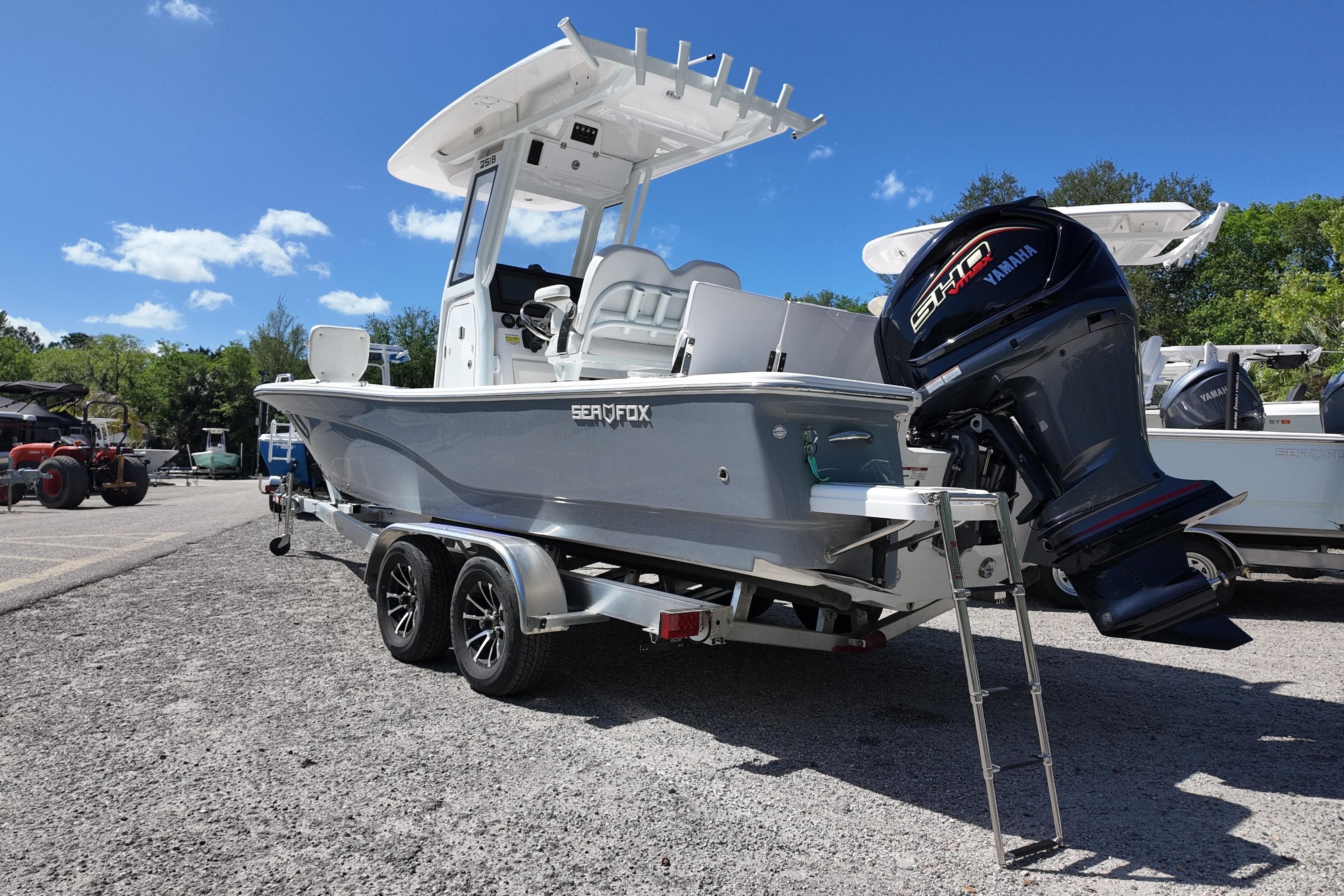 2026 Sea Fox 251 Bay Fox boat on trailer with Yamaha engine, parked outdoors.