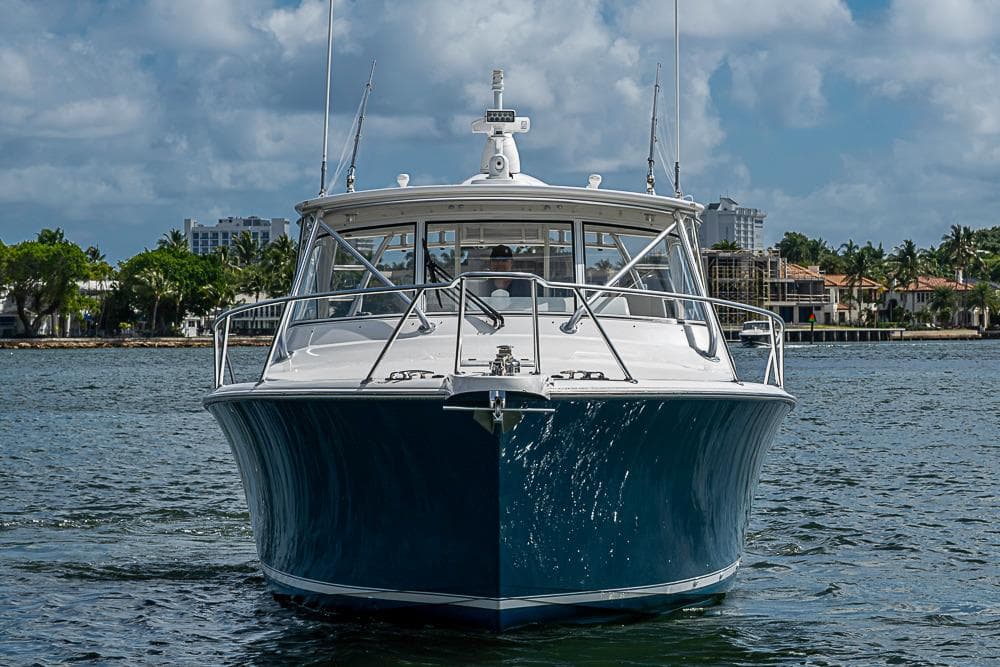 2021 Viking 38 Open yacht on water, front view with coastal background.