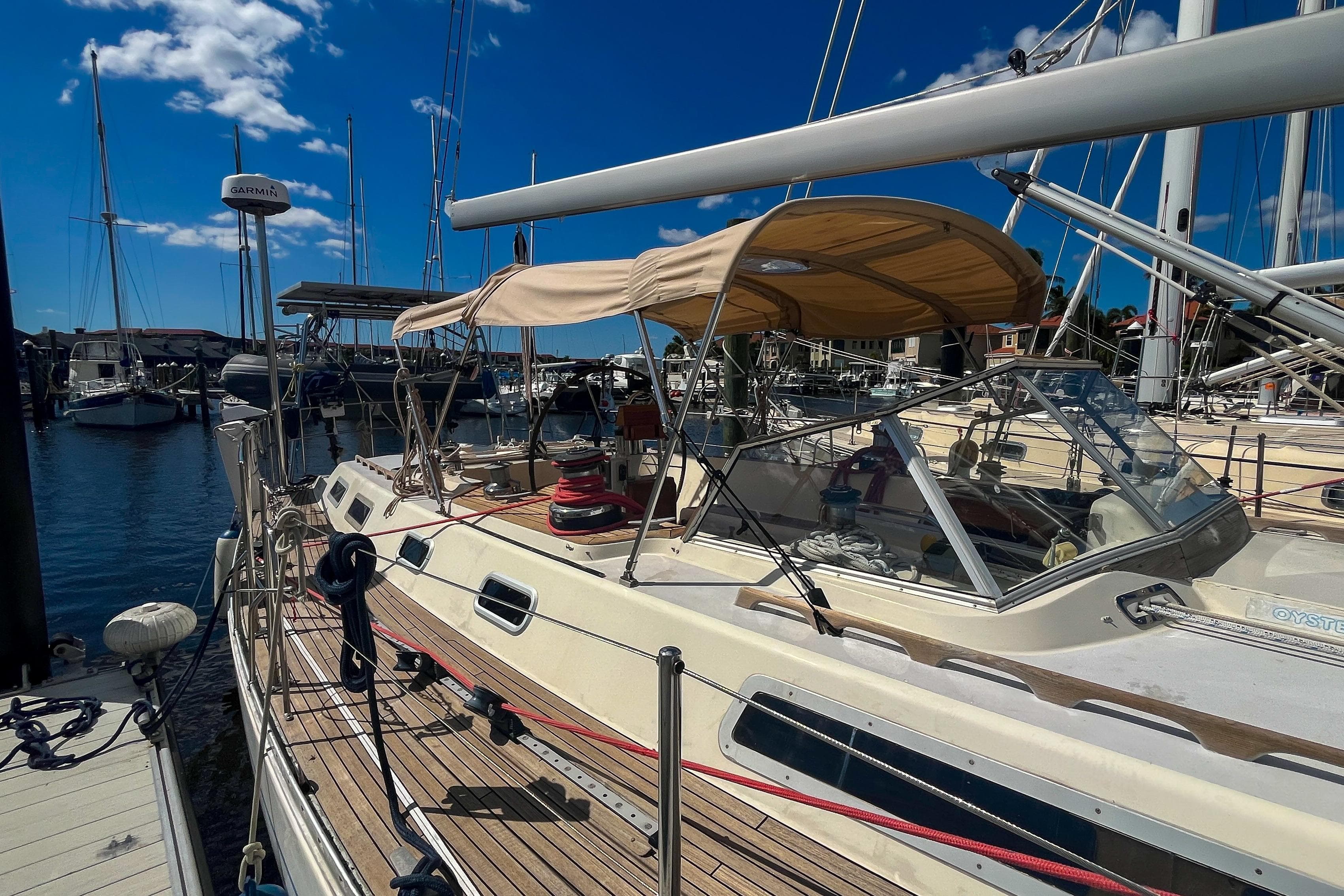 Sailing yacht Oyster LW48, 1991 model, docked at marina under clear blue sky.