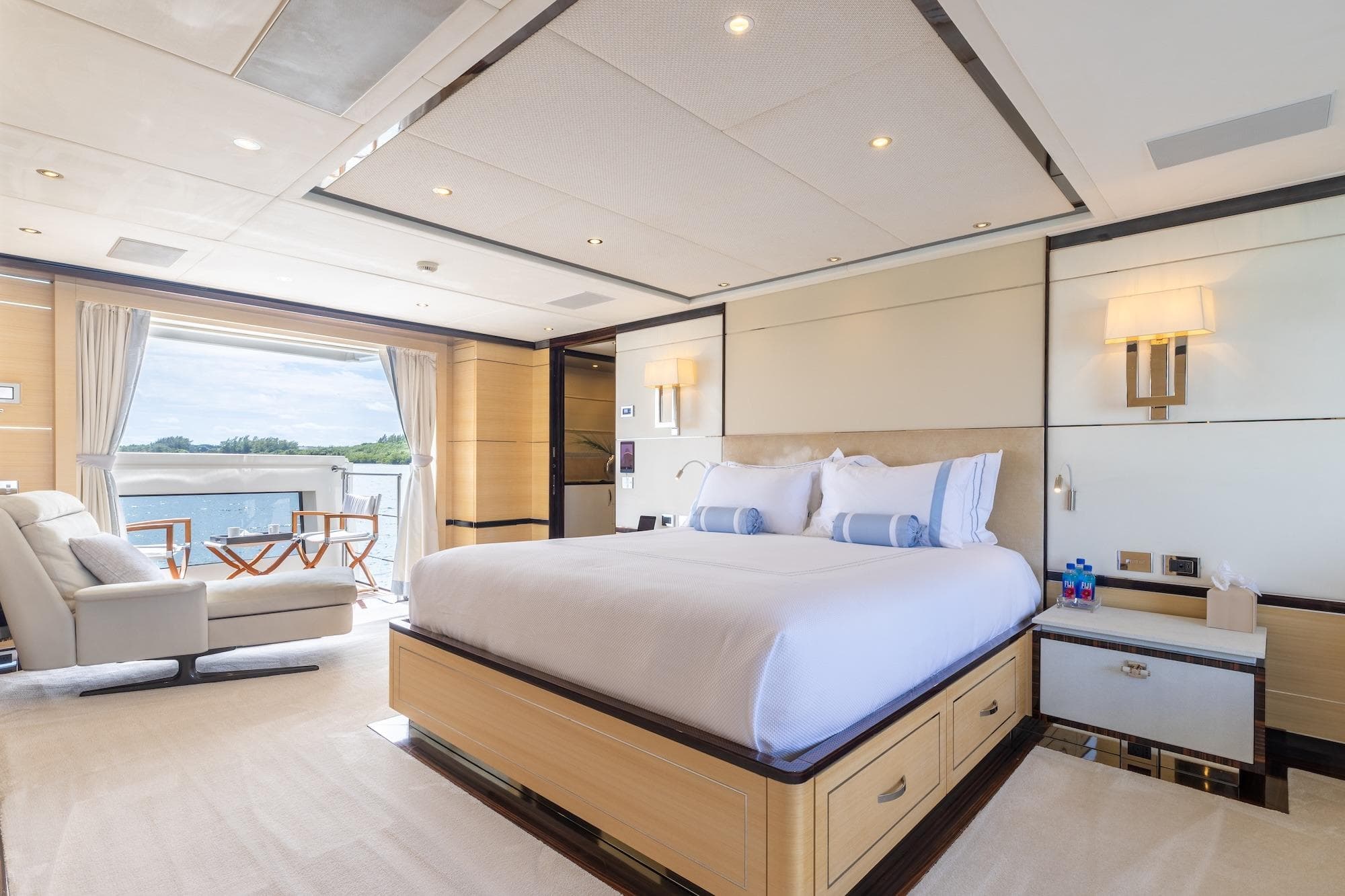 Luxurious bedroom on 2018 Benetti Fast 125 yacht with ocean view and elegant furnishings.