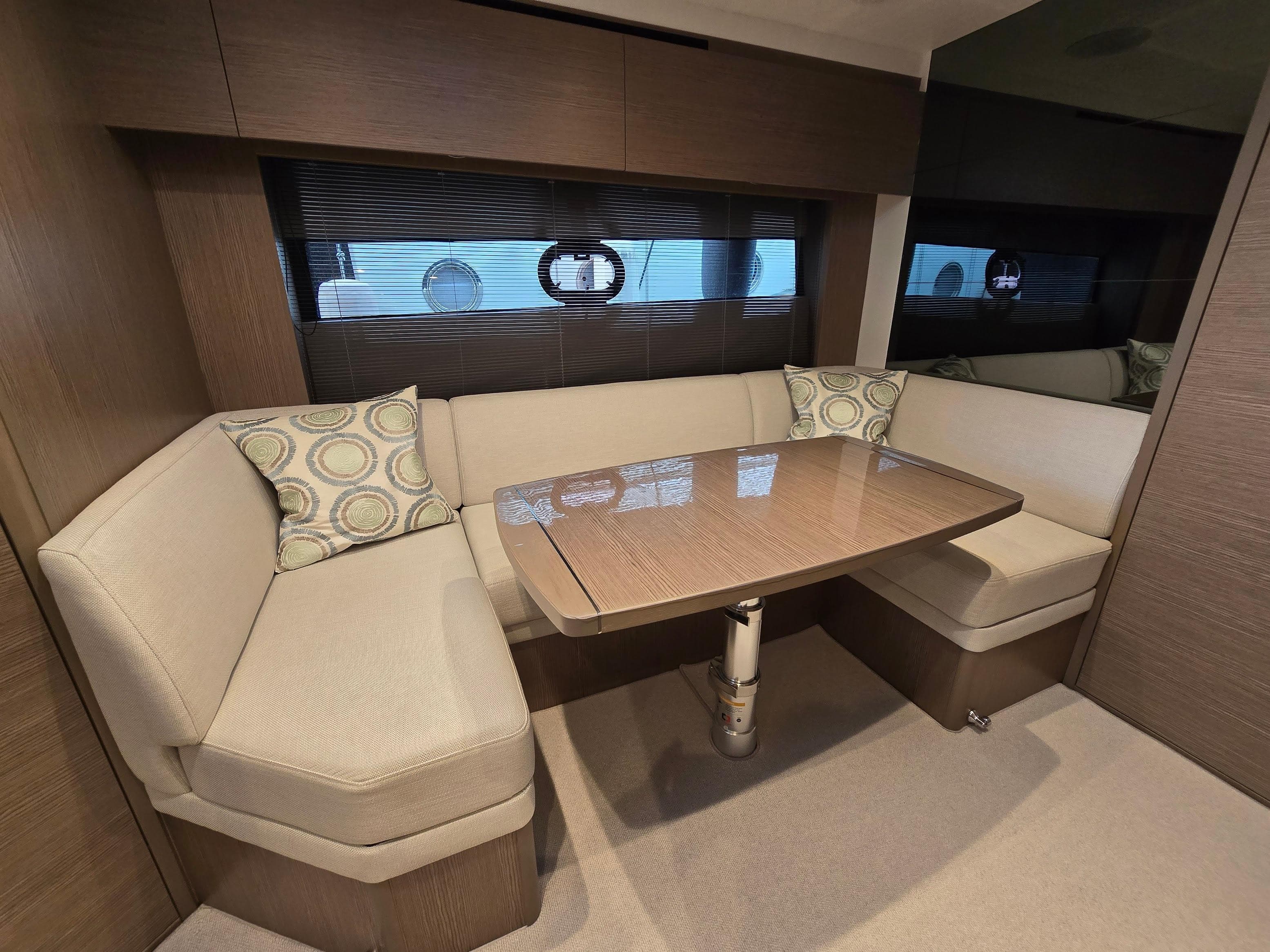2024 Princess V40 yacht interior with elegant dining area and plush seating.