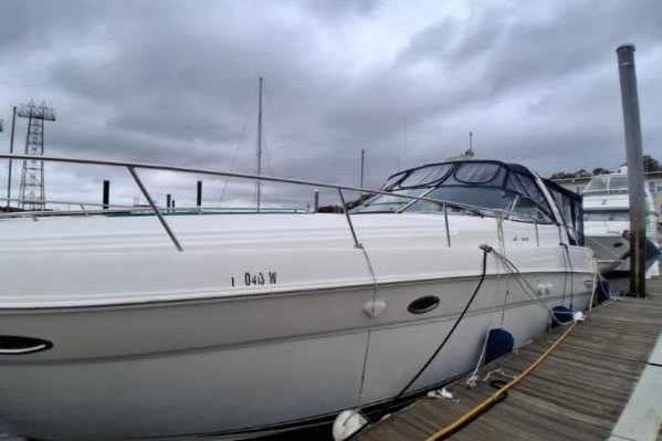 2000 Sea Ray 460 Sundancer yacht docked under cloudy skies.