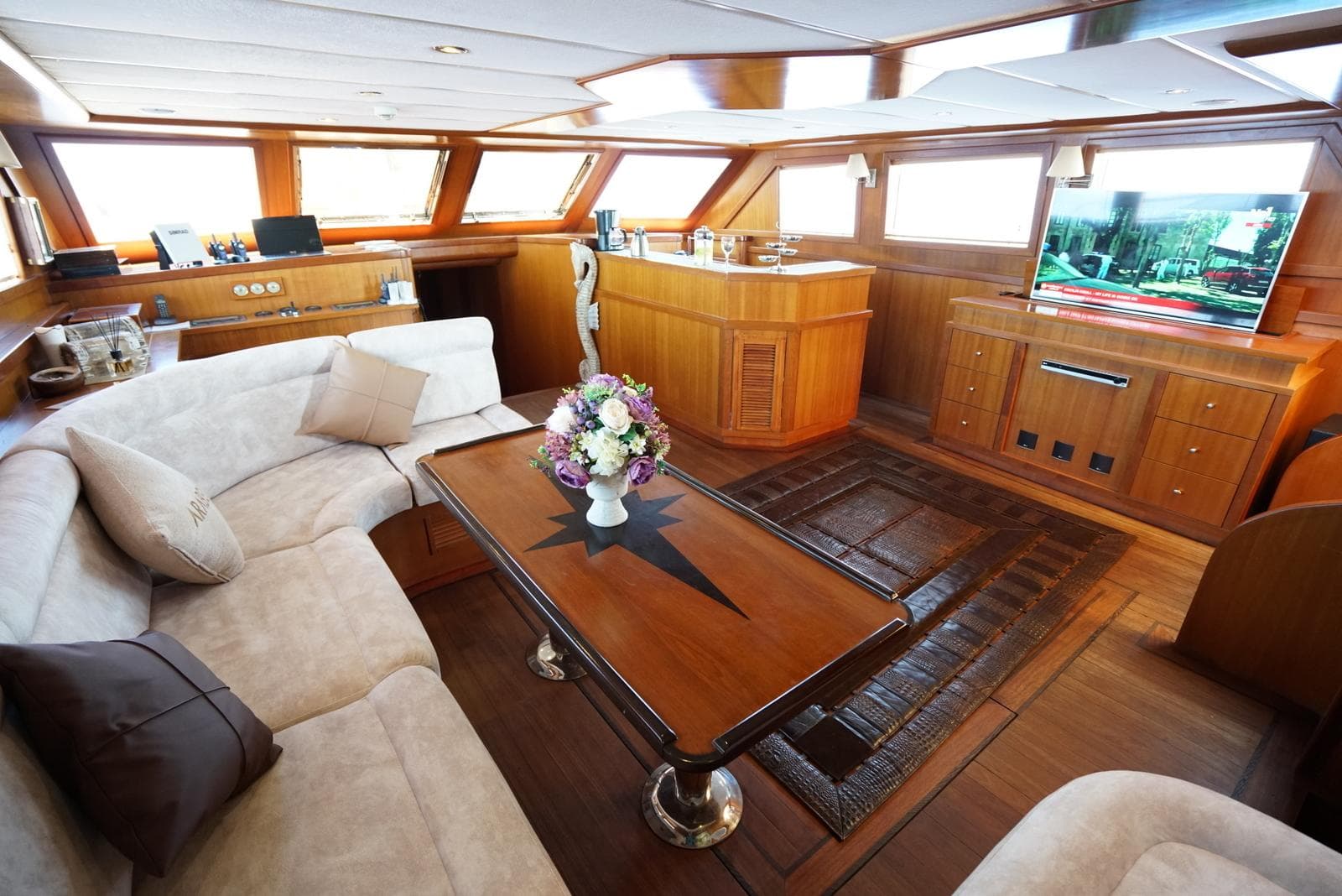 Luxurious interior of a 2007 custom 32-metre gulet with elegant wood finishes and plush seating.
