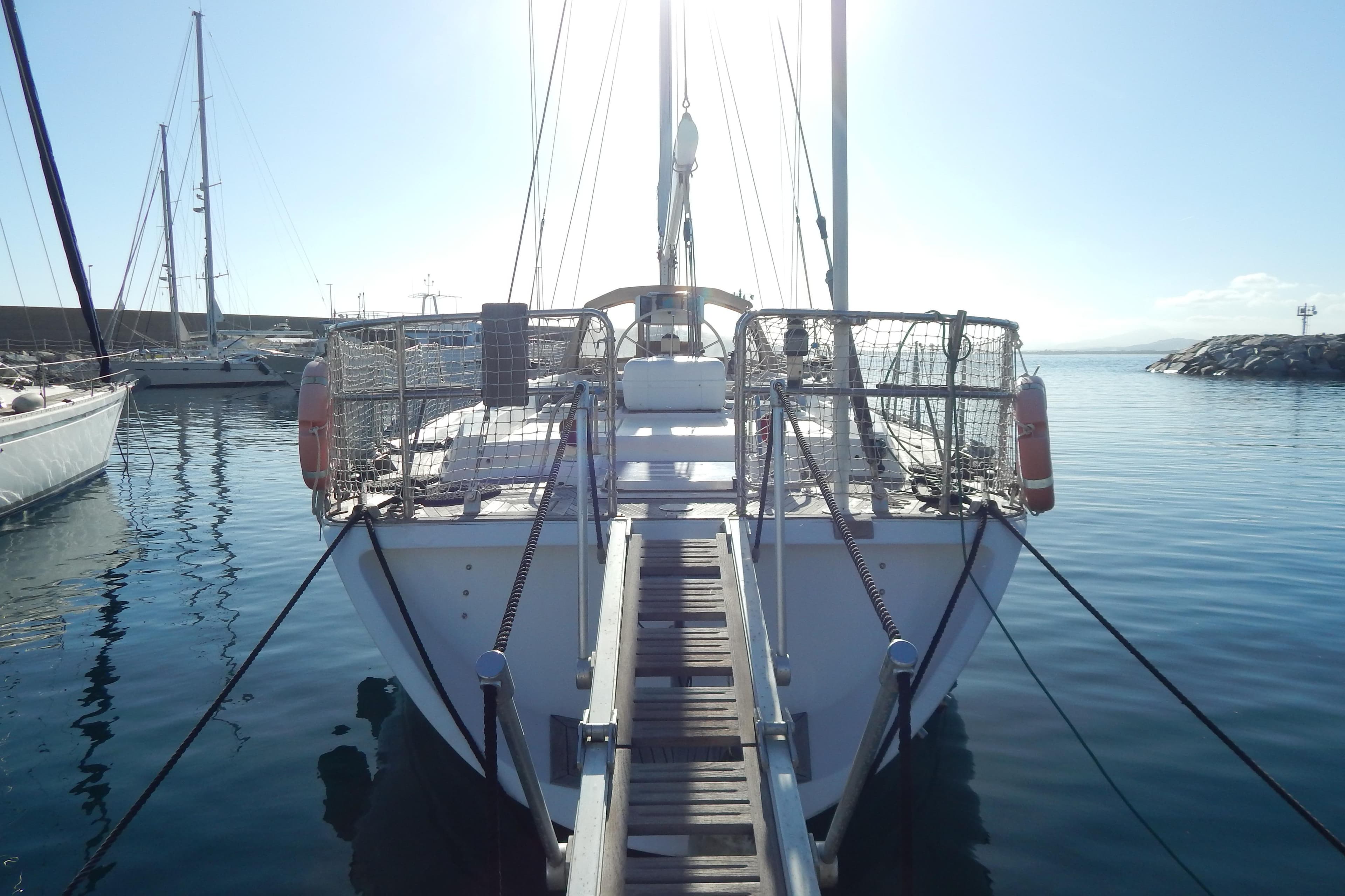 Sailboat docked in marina, Tayana 55 model, 1992, with clear blue sky.