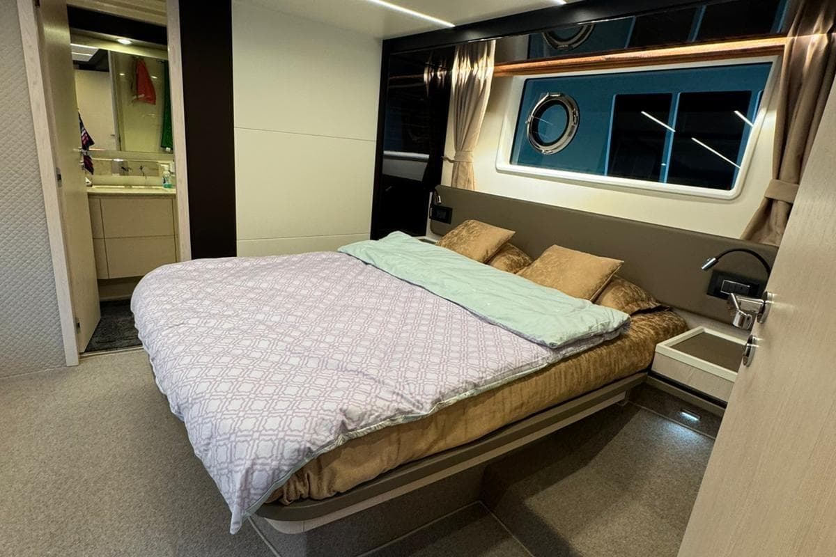 Luxurious bedroom interior of 2017 Azimut AZIMUT 66 yacht with modern design and ensuite bathroom.