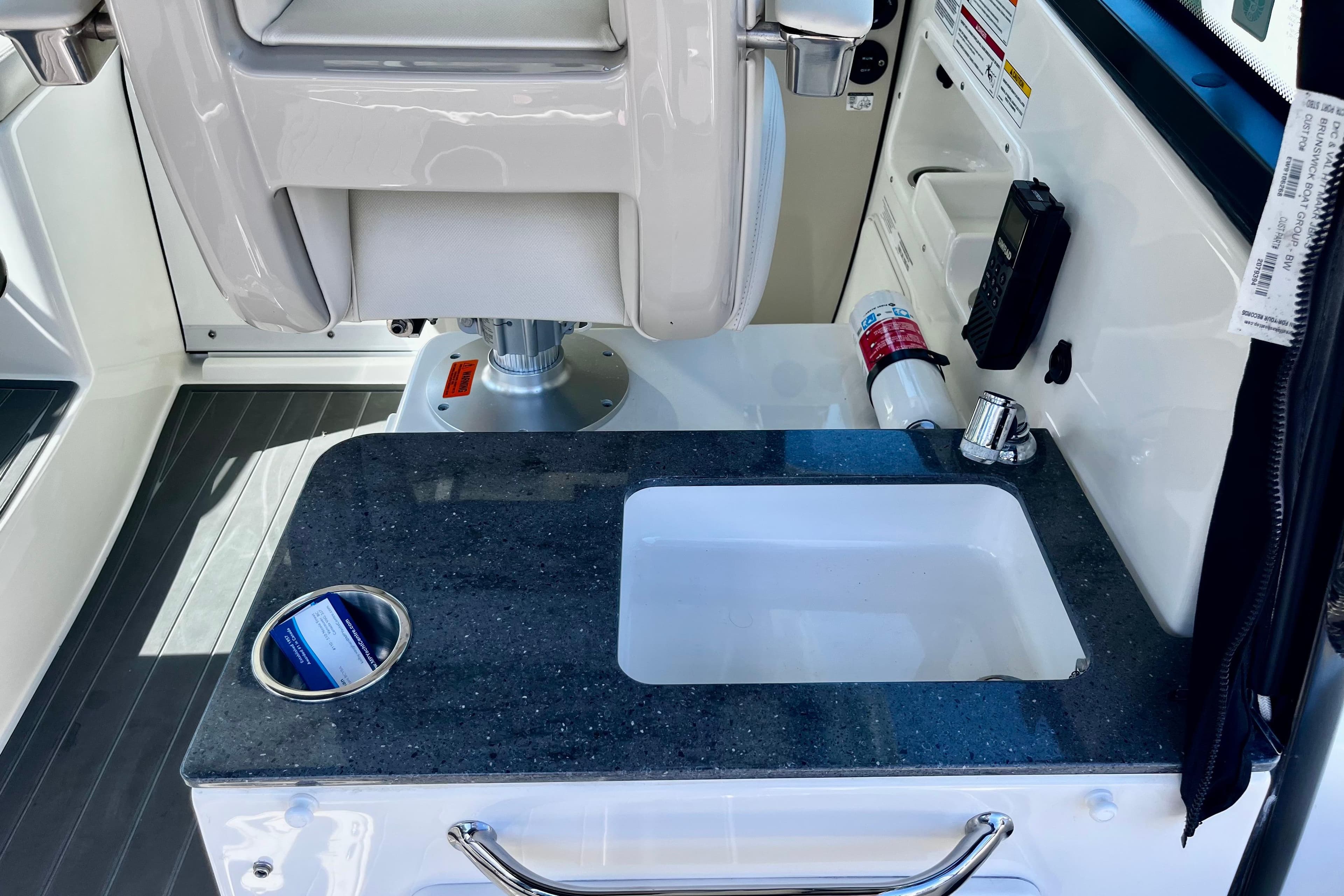 2023 Boston Whaler 285 Conquest interior with sink and seating area.