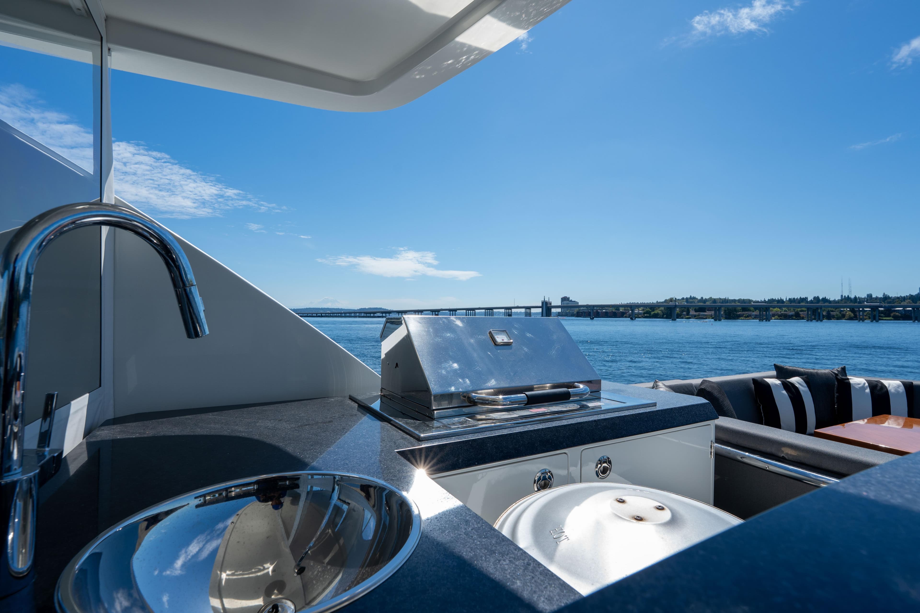 Outdoor kitchen on 2017 Ocean Alexander 70 E yacht with scenic water view.
