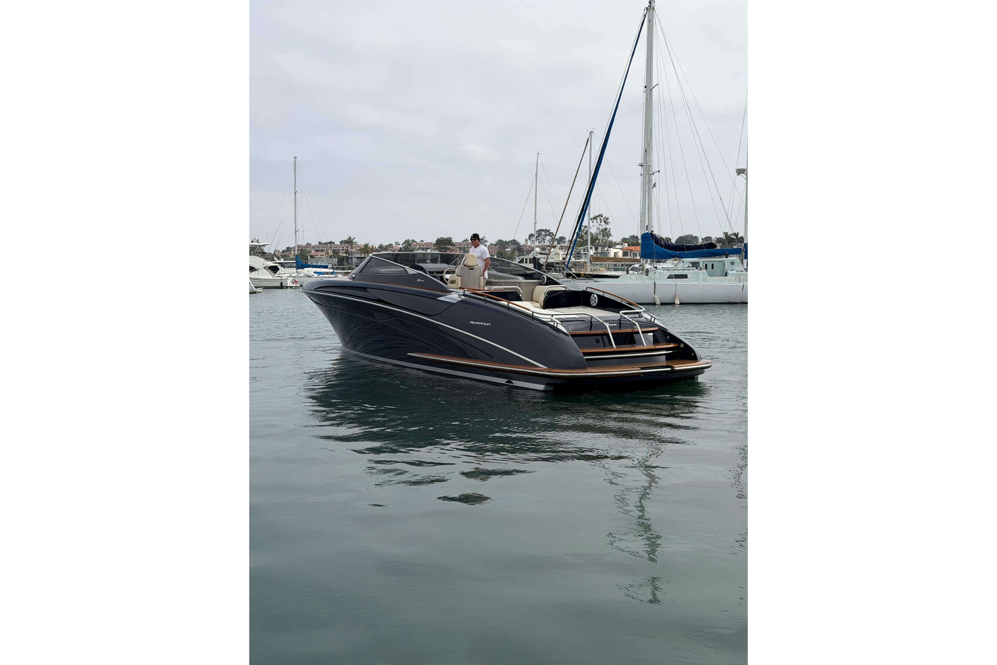 Luxurious 2012 Riva 44' Rivarama yacht docked in a serene marina setting.