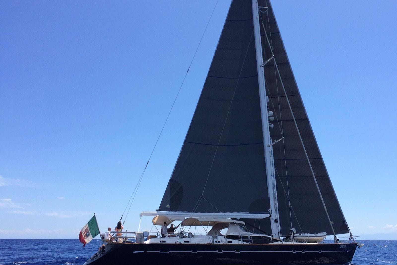 Sailing yacht Oyster 825, 2004 model, with black sails on open sea.