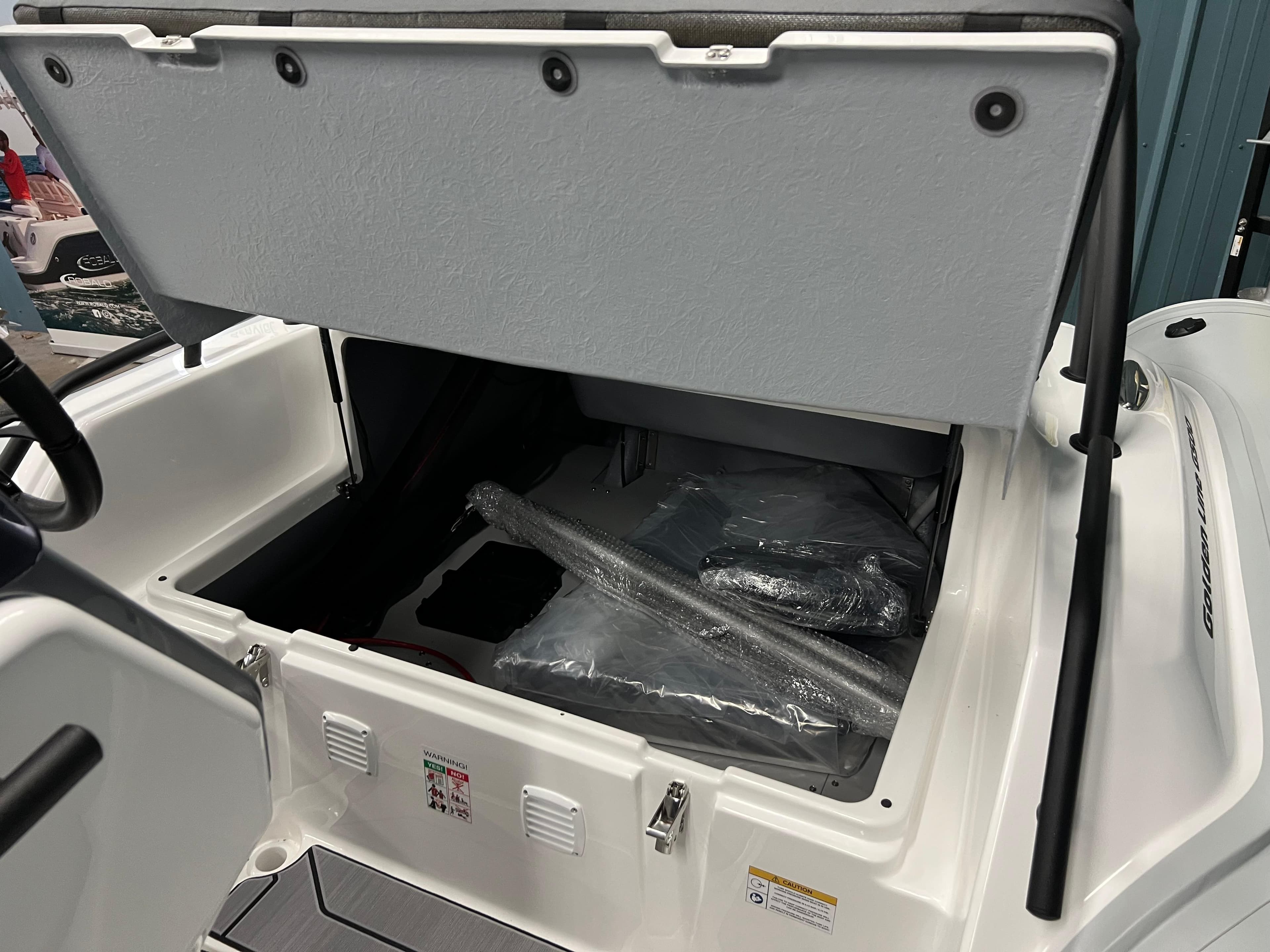 Open storage compartment in 2025 Grand G500HLF boat, showing interior space and packaging materials.