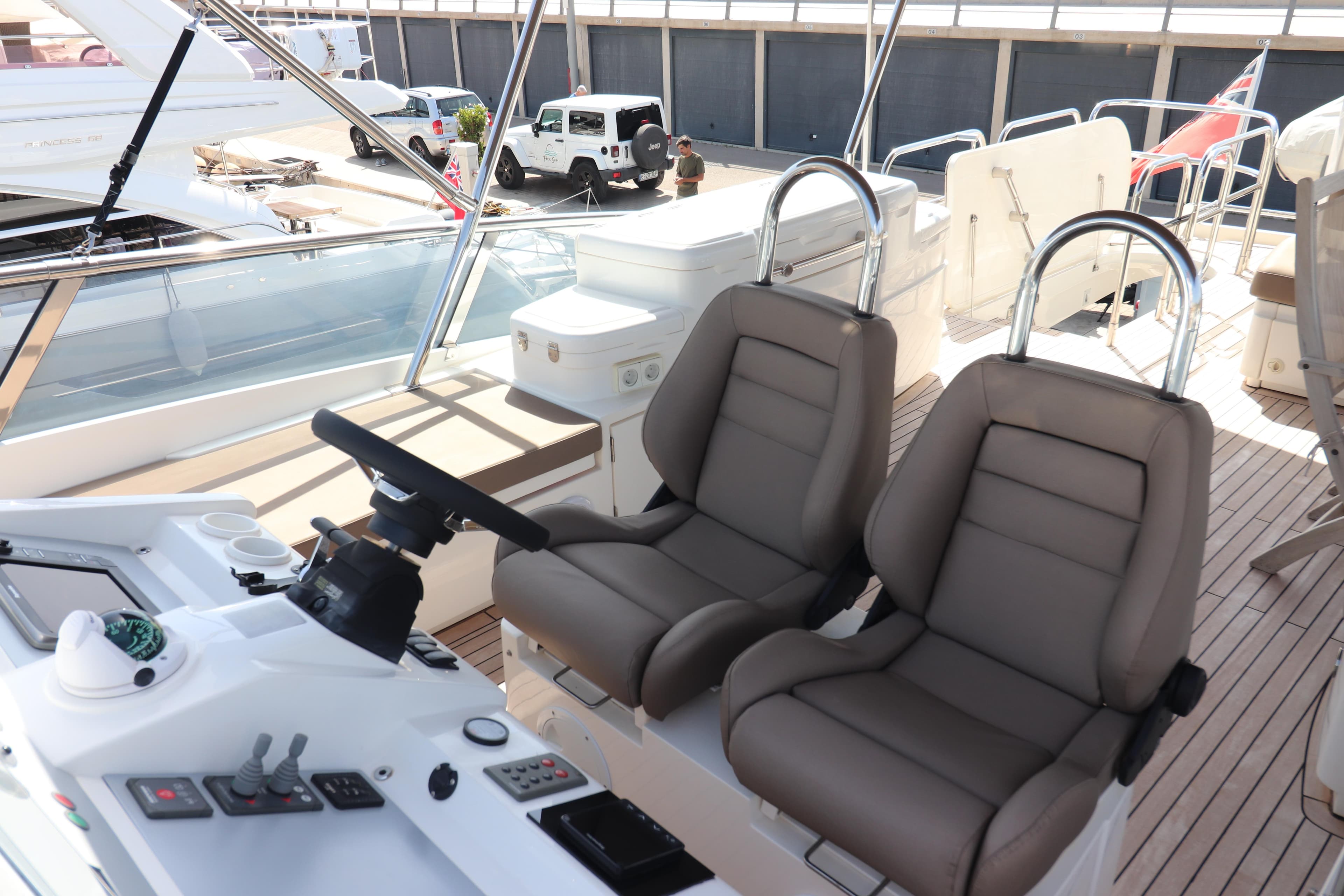 Luxurious helm seating on 2007 Fairline Squadron 68 yacht, featuring modern controls and sleek design.
