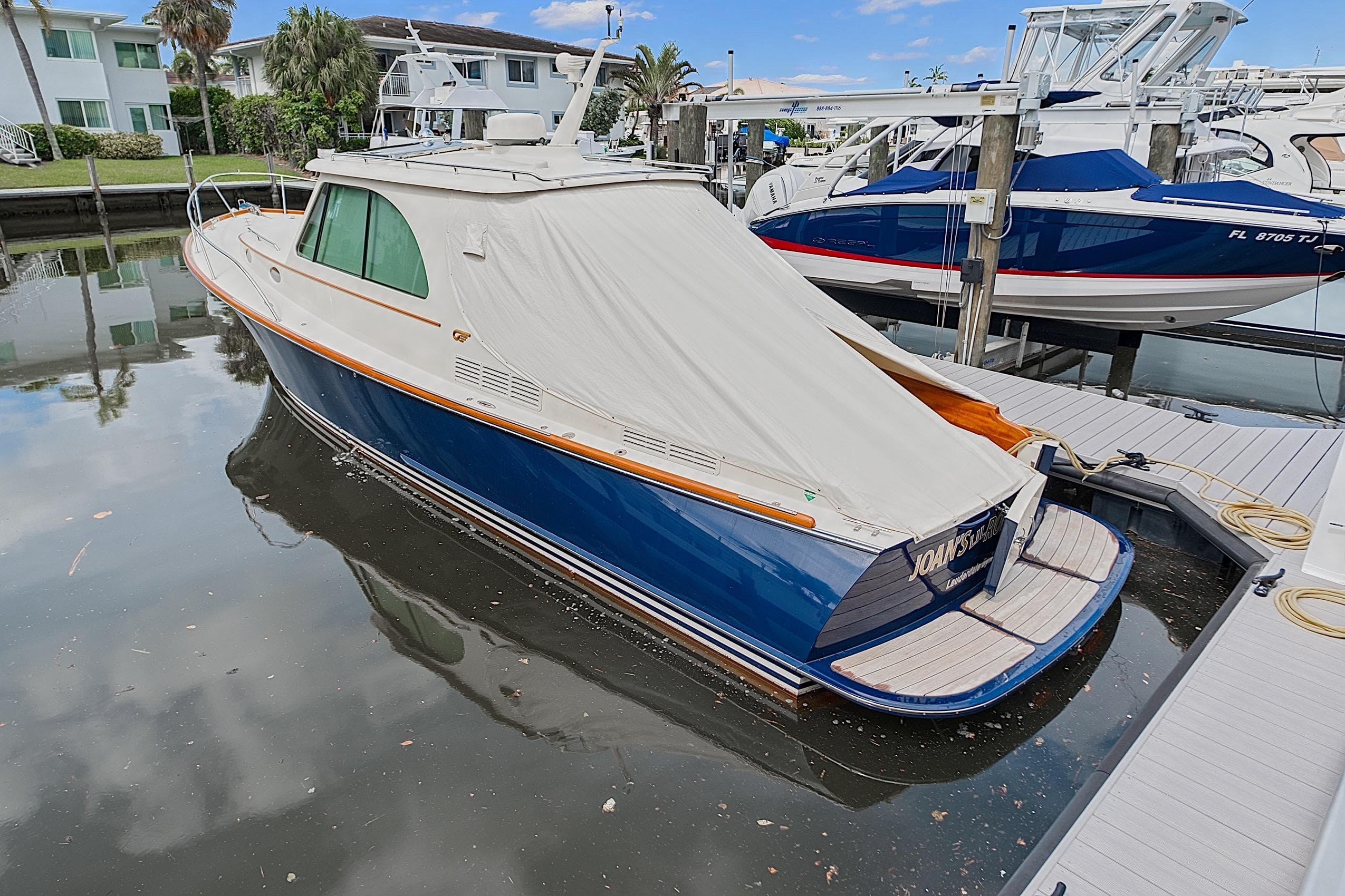2018 Hinckley Picnic Boat 37 MKIII docked, covered, in a marina setting.