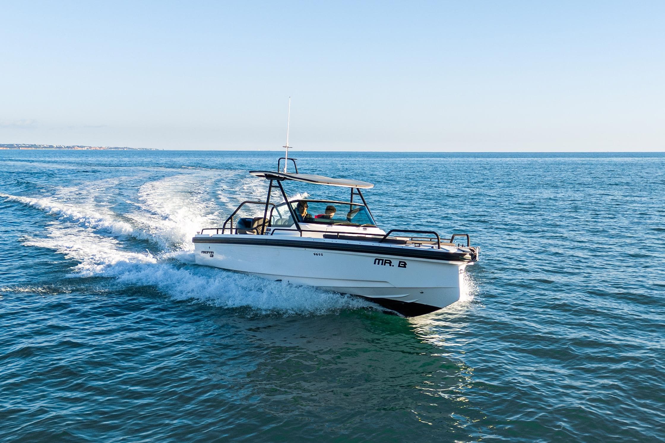 2019 Axopar 28 T-Top boat cruising on open water under clear skies.