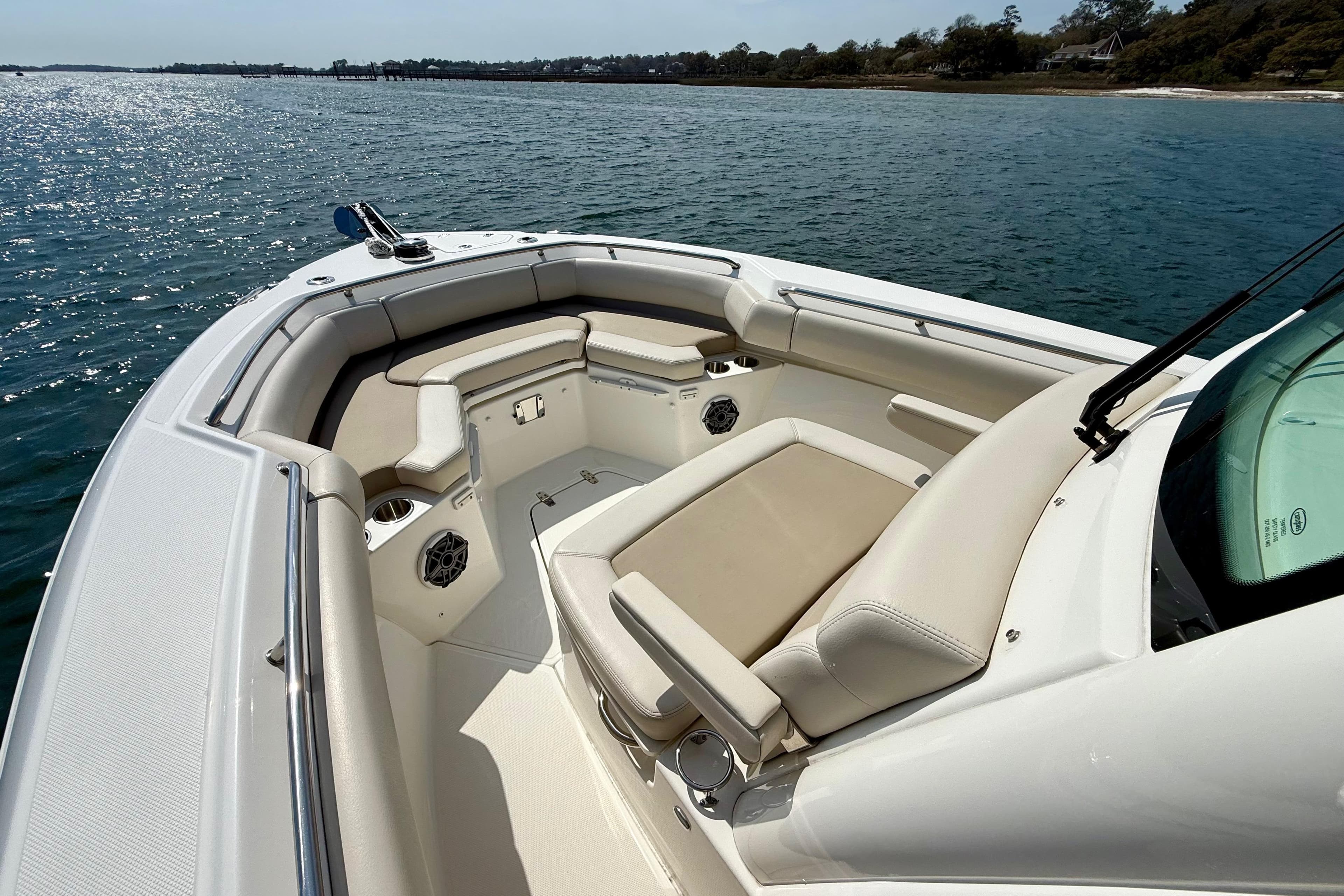 2024 Boston Whaler 250 Outrage boat interior with cushioned seating on the water.