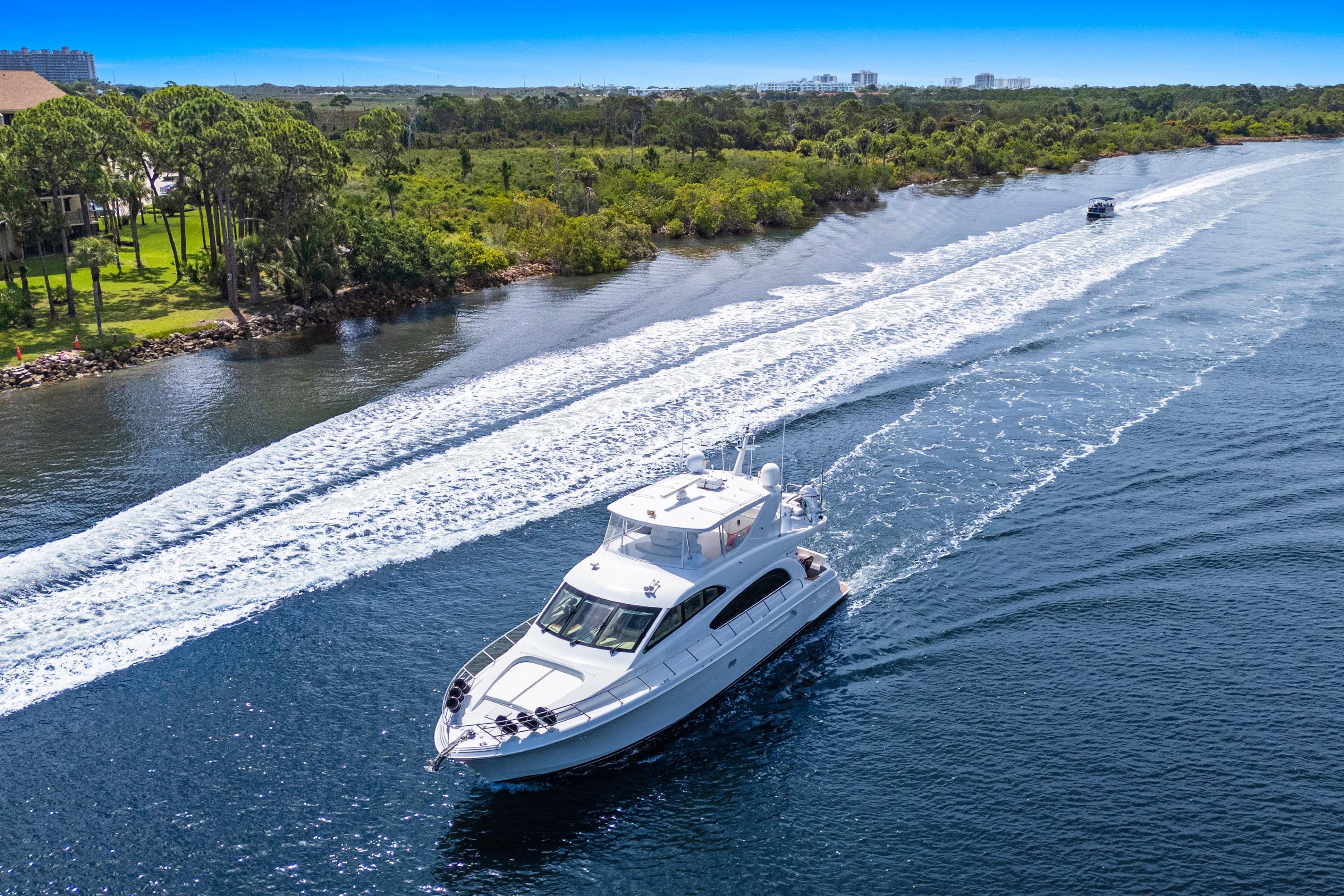 2008 Hatteras 64 Motor Yacht cruising on a scenic waterway.