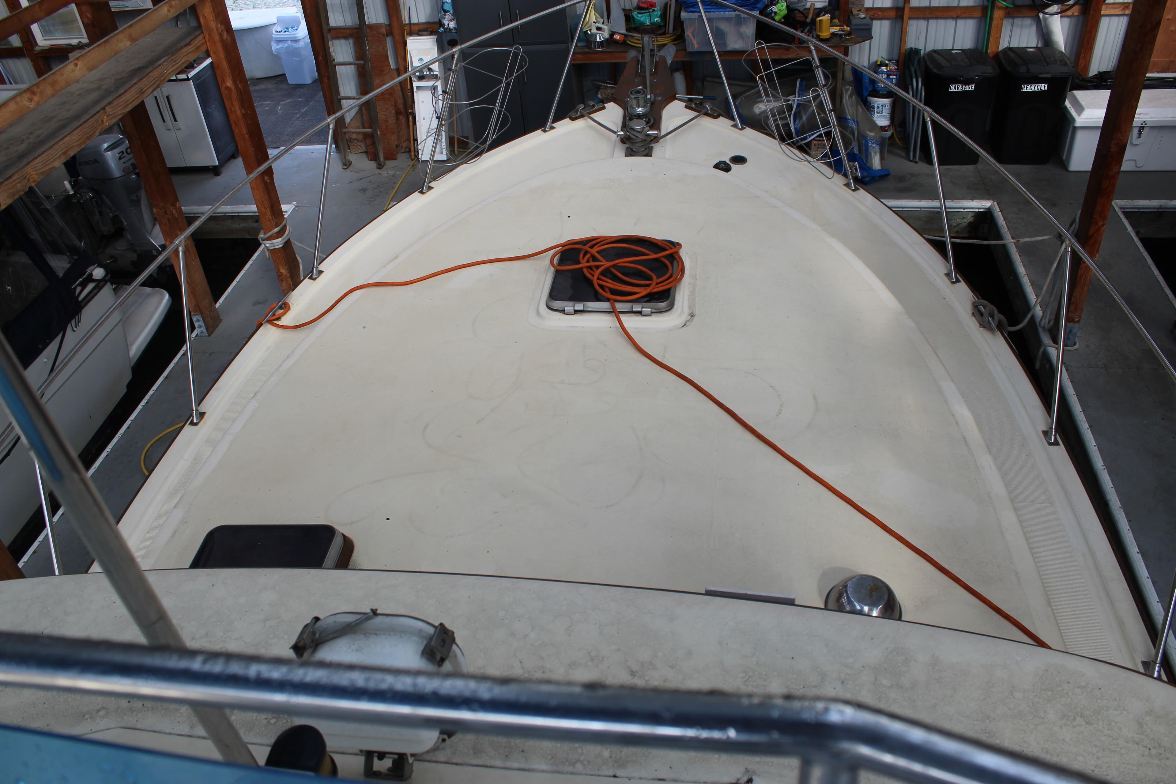 1985 Ventura South Bay Flybridge Sedan Sport boat deck in a storage facility.