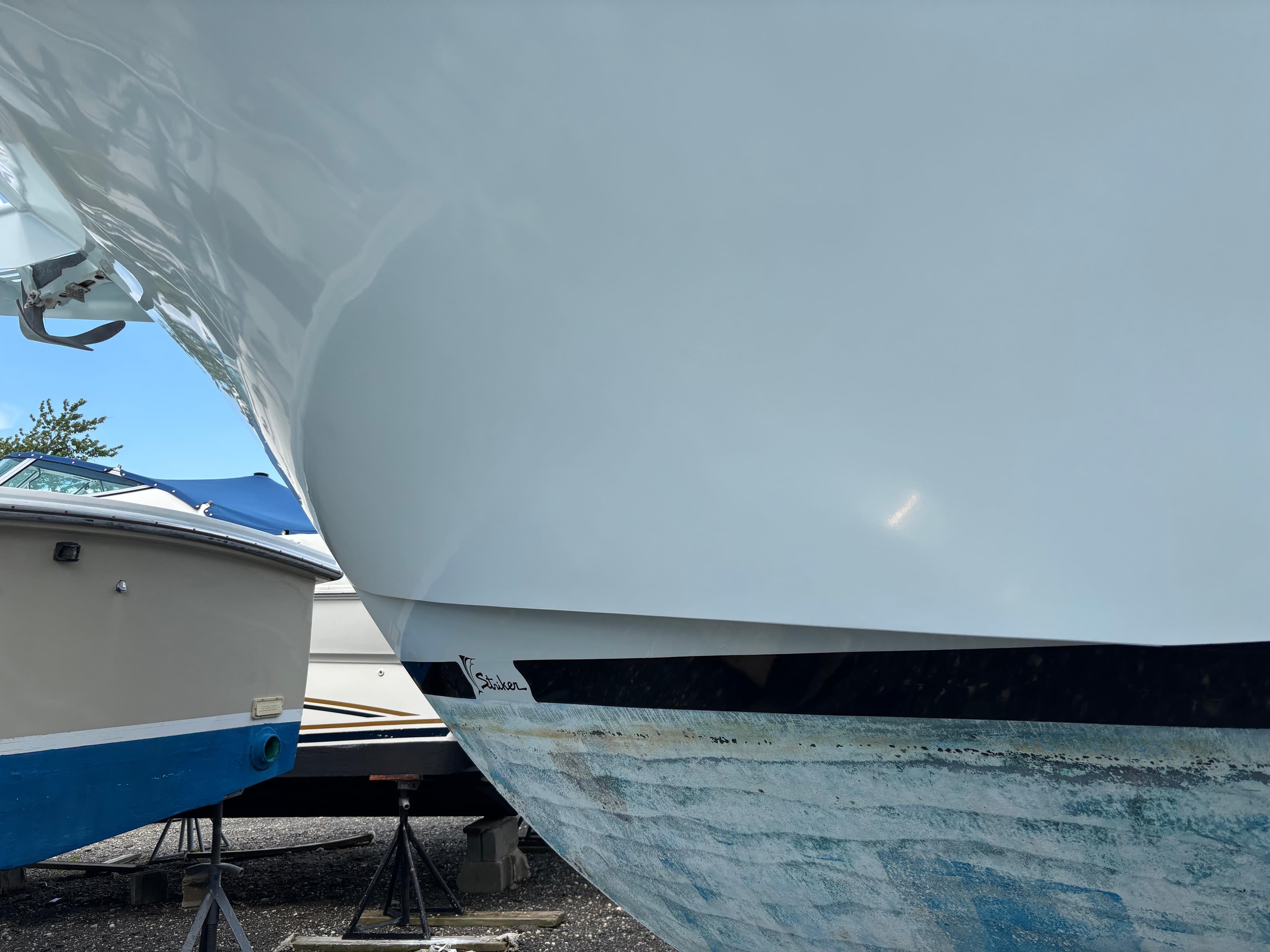 1974 Striker Canyon Runner boat hull on stands, with visible anchor and adjacent boats.