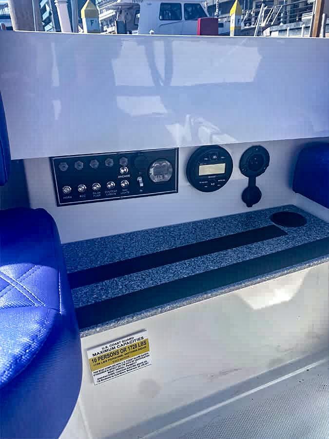 2023 Vision Marine Technologies Fantail 217 dashboard with controls and blue seating.
