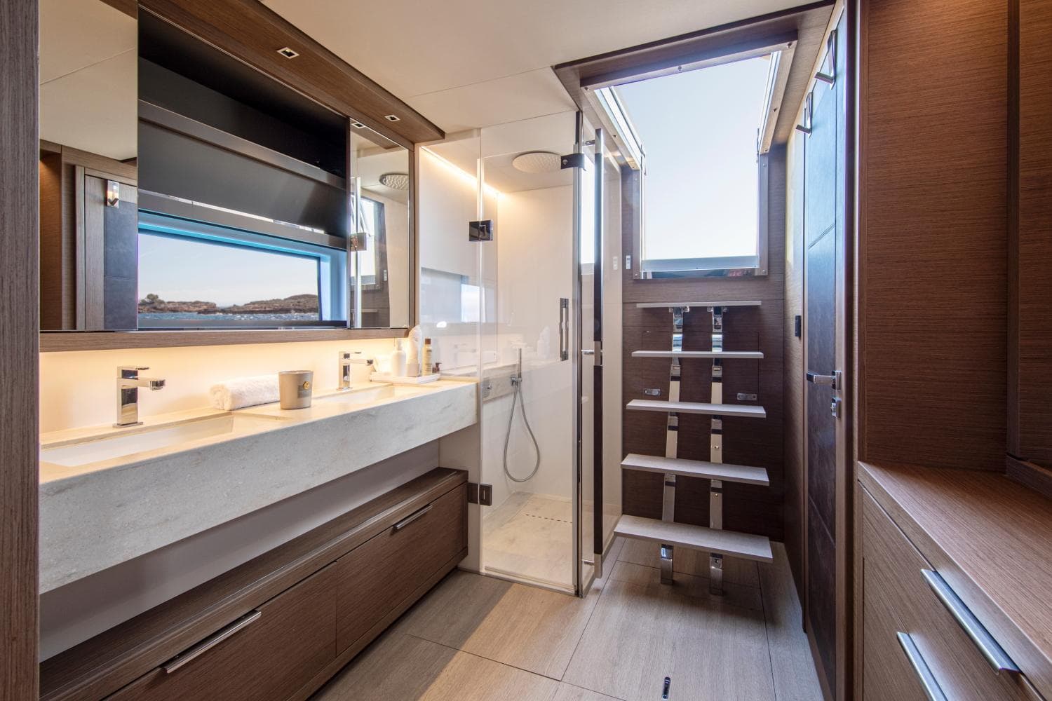 Luxurious bathroom in 2021 Lagoon SIXTY 5 yacht, featuring modern fixtures and elegant wood finishes.