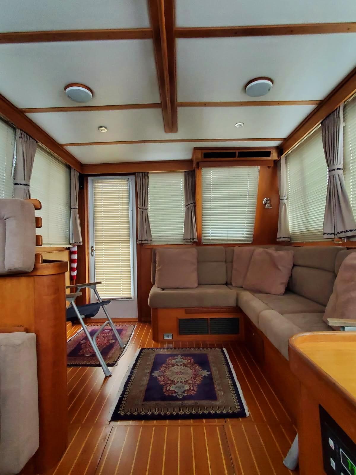 Interior of 2004 Sabre 36 Flybridge Fast Trawler with cozy seating and elegant wood finish.